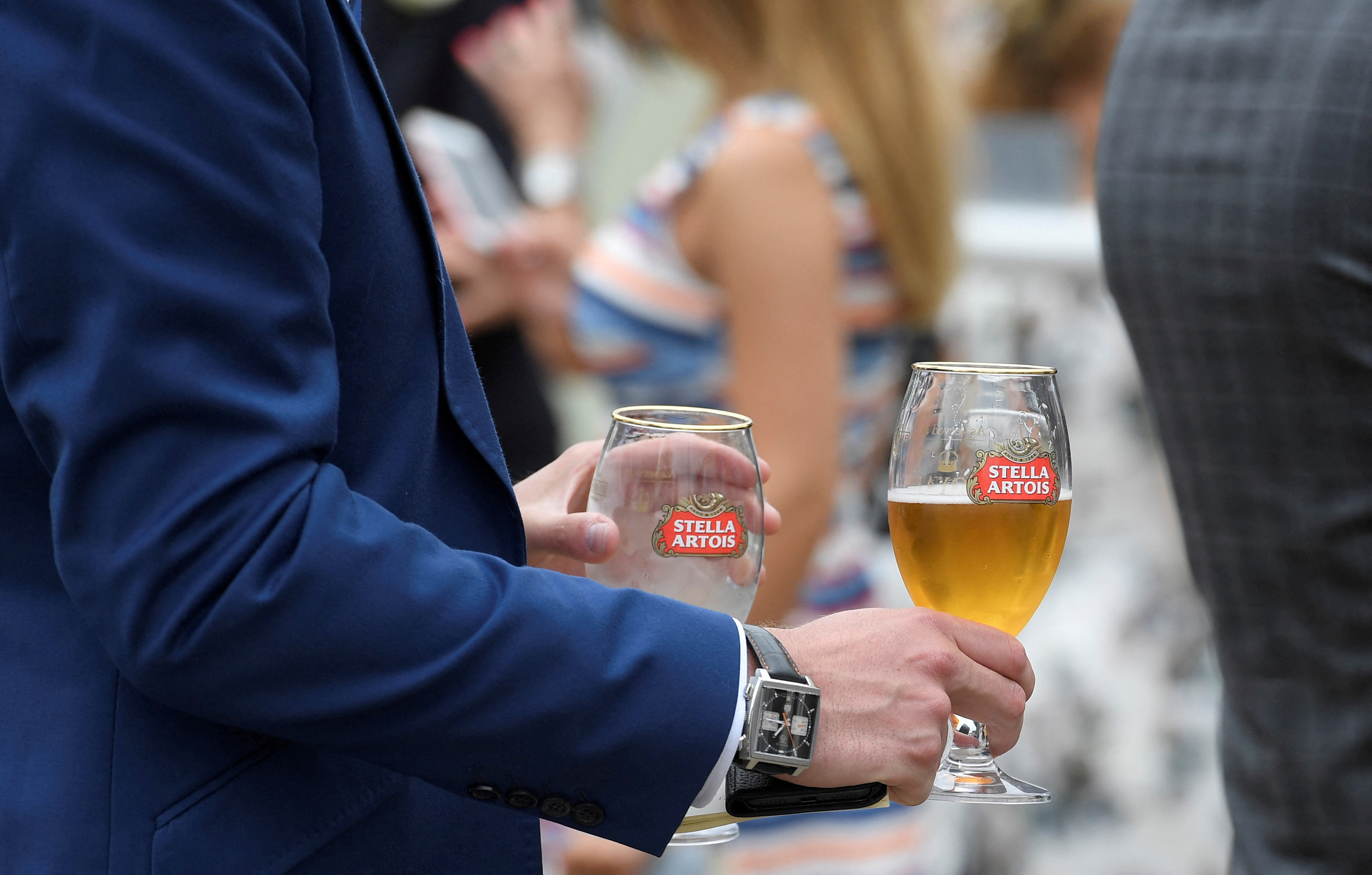 A racegoers drinks Stella Artois beer at the Ascot racecourse at Ascot