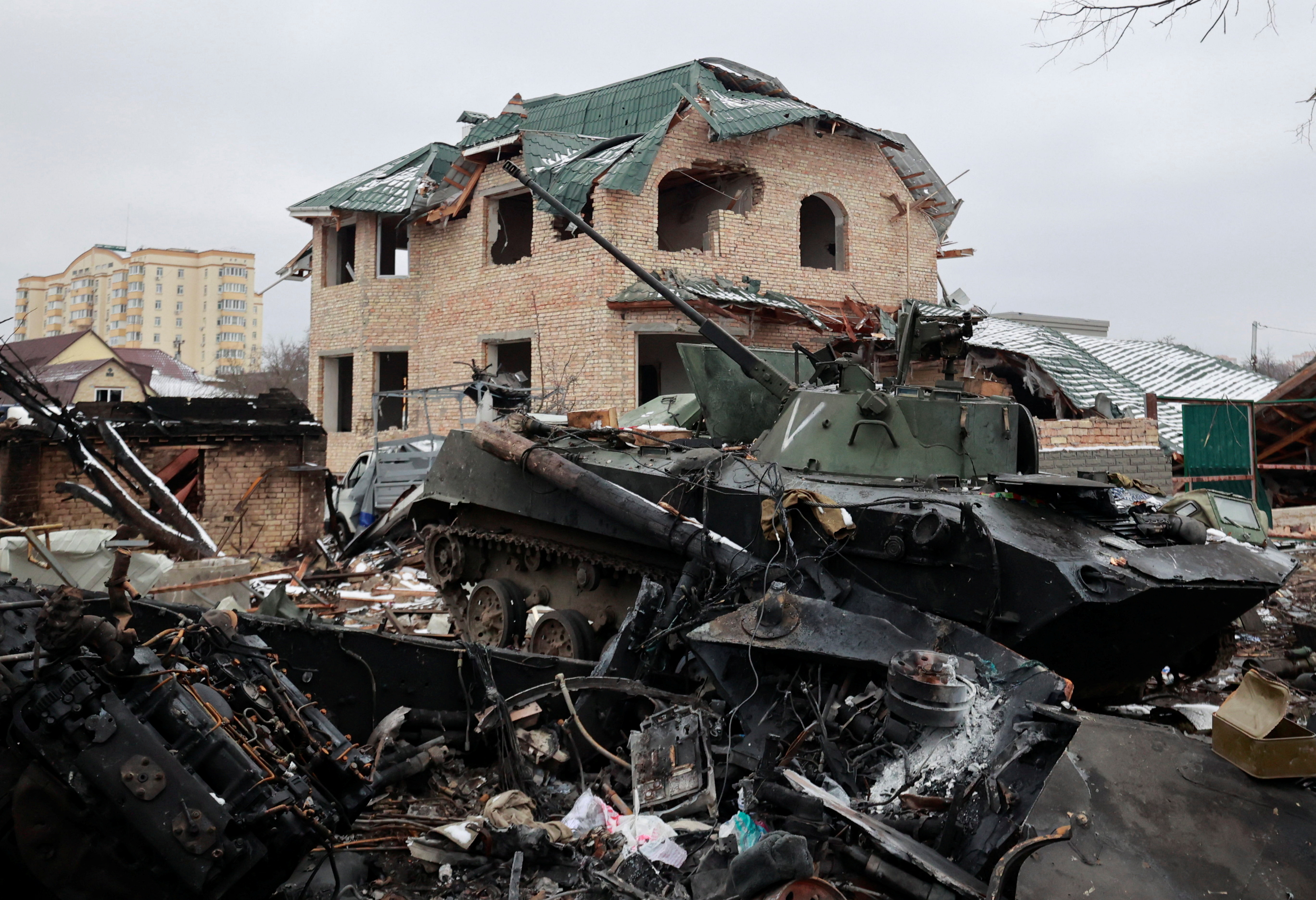 A destroyed armoured vehicle is seen on a street in Bucha