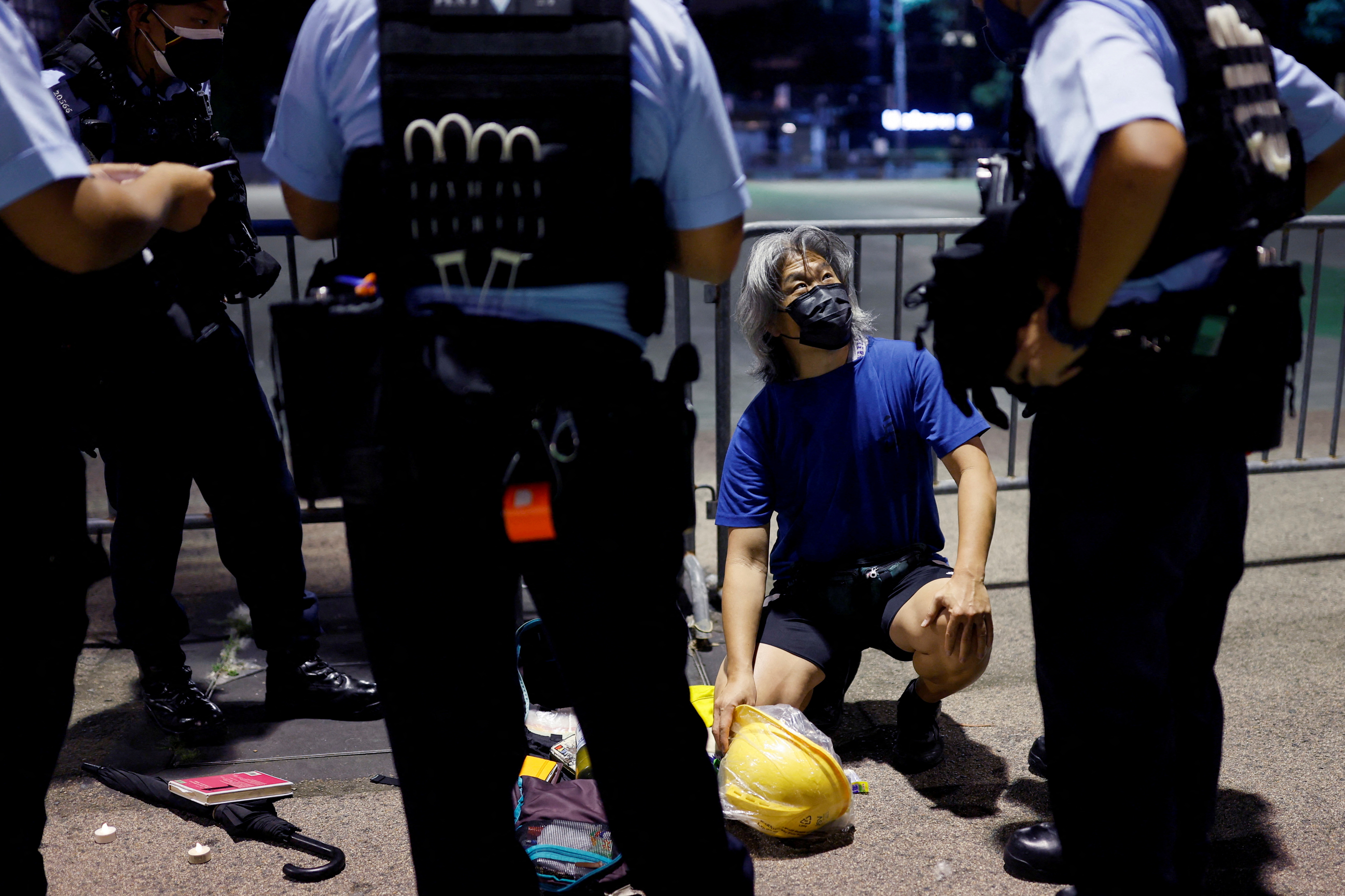 Police officers search a man at Victoria Park, ahead of Tiananmen anniversary, in Hong Kong