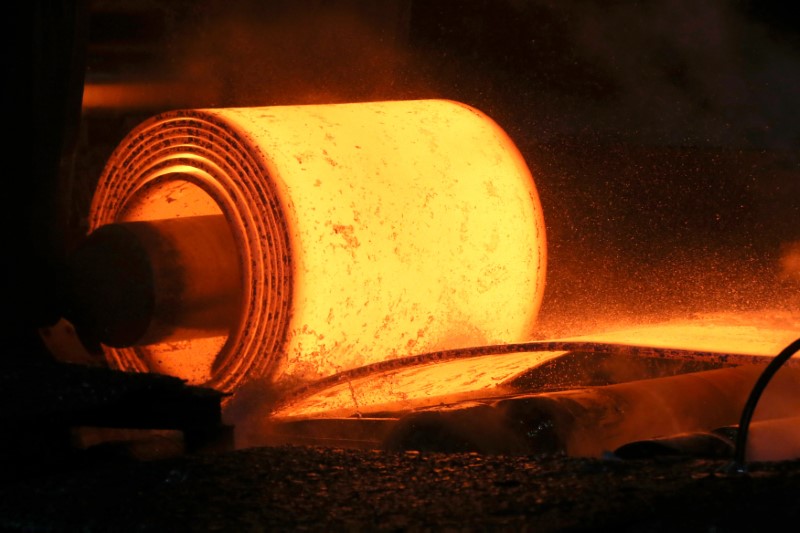 A steel coil is unrolled on the line at the Novolipetsk Steel PAO steel mill in Farrell, Pennsylvania