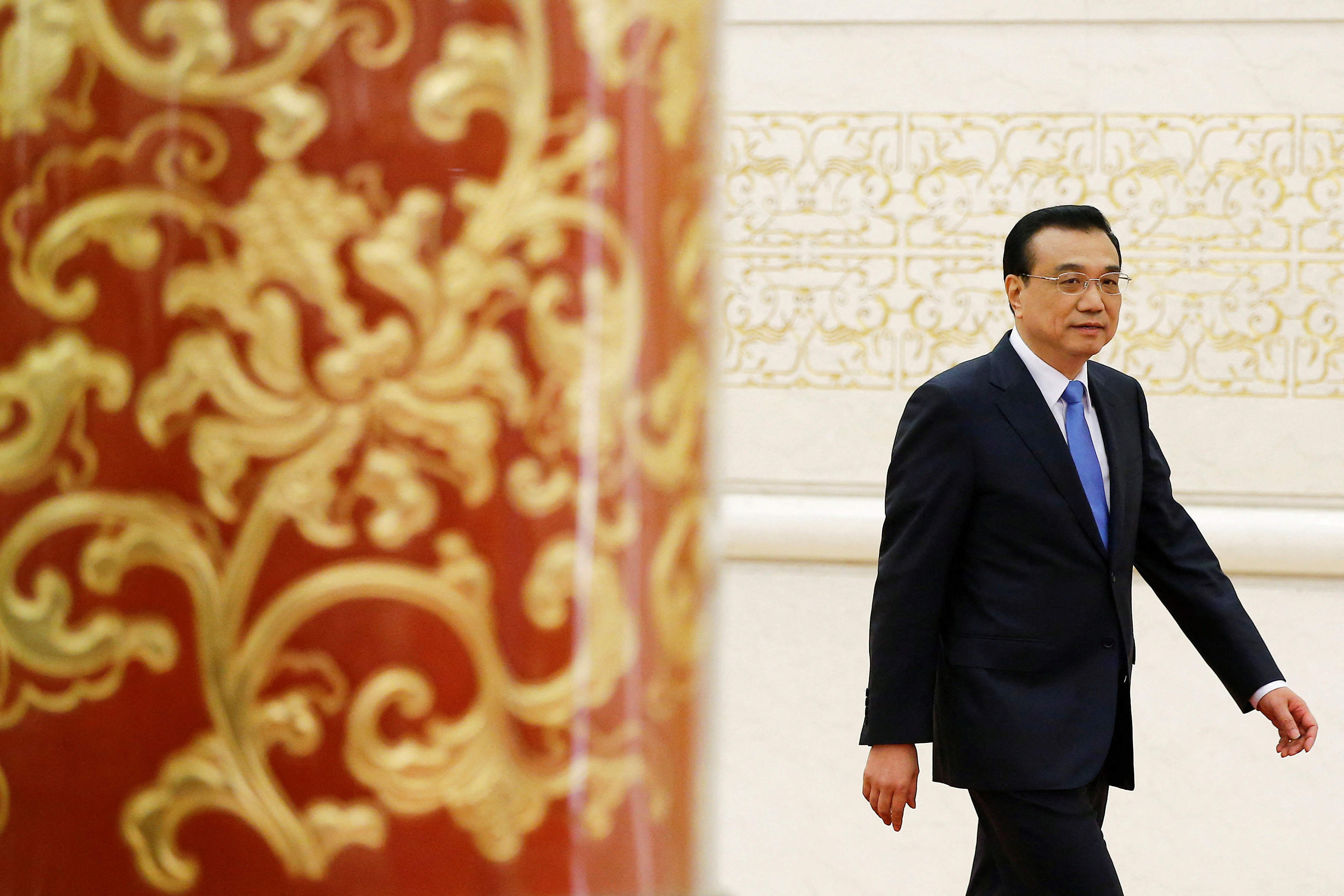 China's Premier Li Keqiang arrives for a news conference after the closing ceremony of China's National People's Congress (NPC) at the Great Hall of the People in Beijing