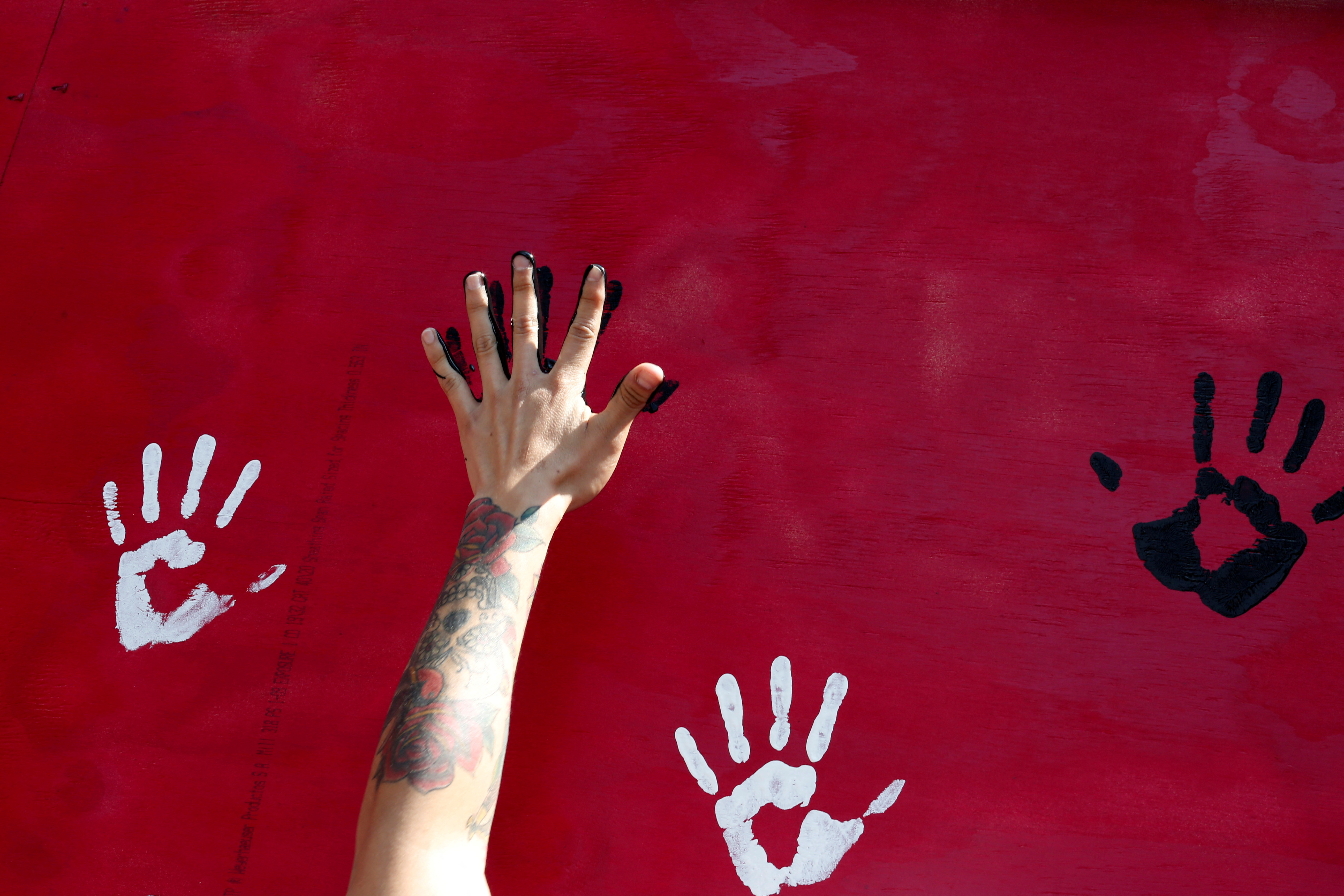 A man places his hand on a mural to honor earthquake victims in Mexico City