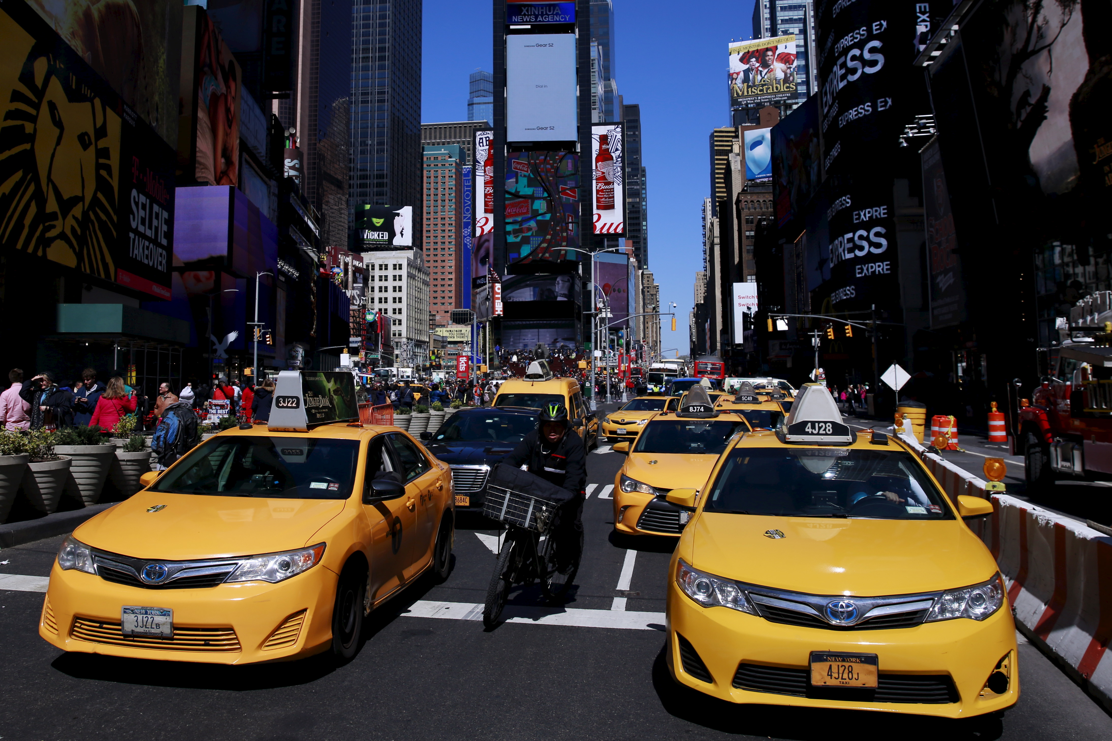 New York City taxi cabs drive through Times Square in New York