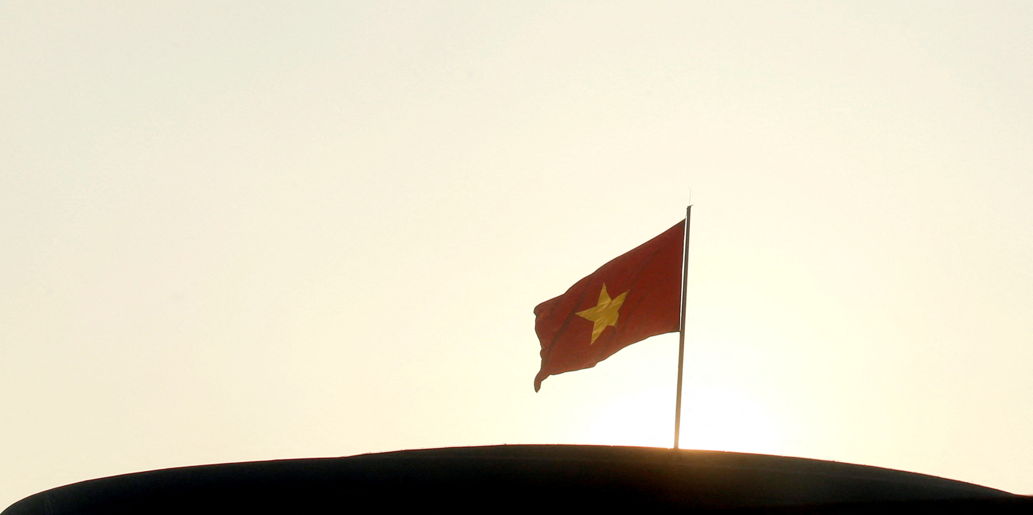 A Vietnamese national flag is seen on the rooftop of the National Assembly's Ba Dinh hall in Hanoi