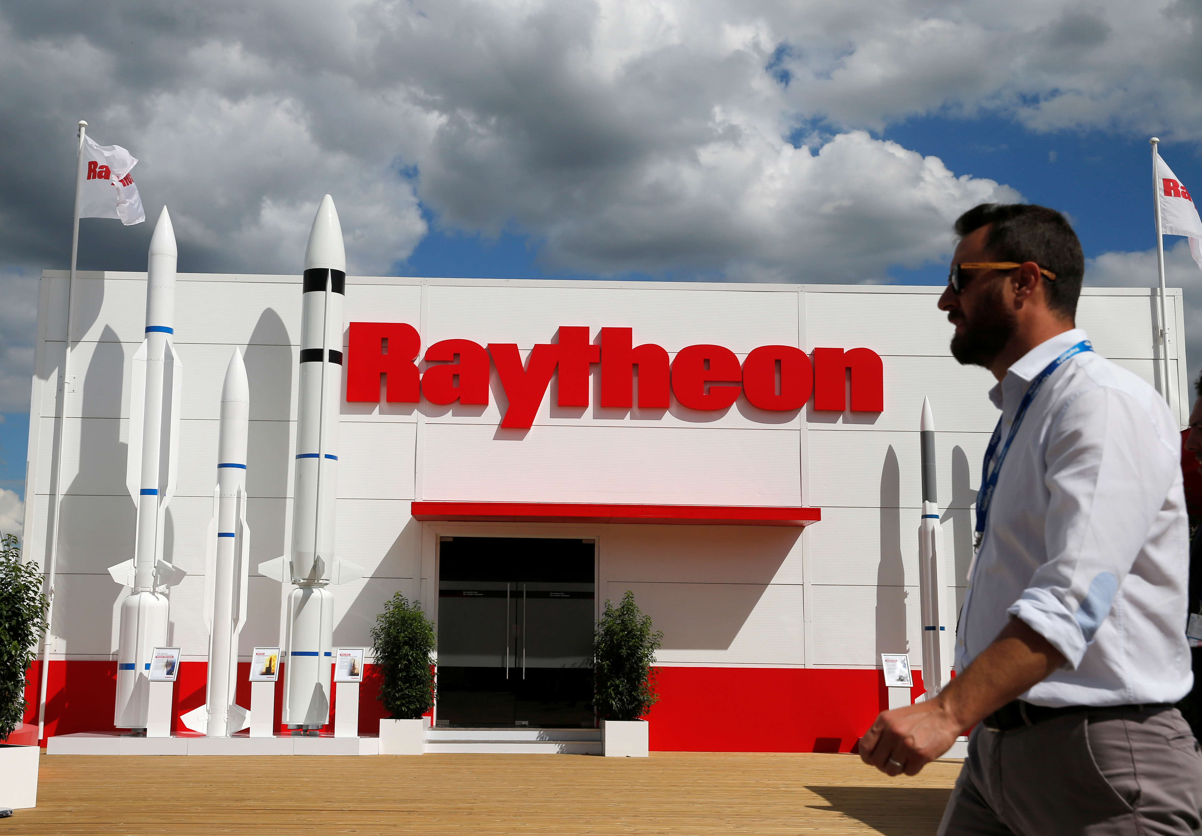 A visitor walks past Raytheon stand at the 53rd International Paris Air Show at Le Bourget Airport near Paris