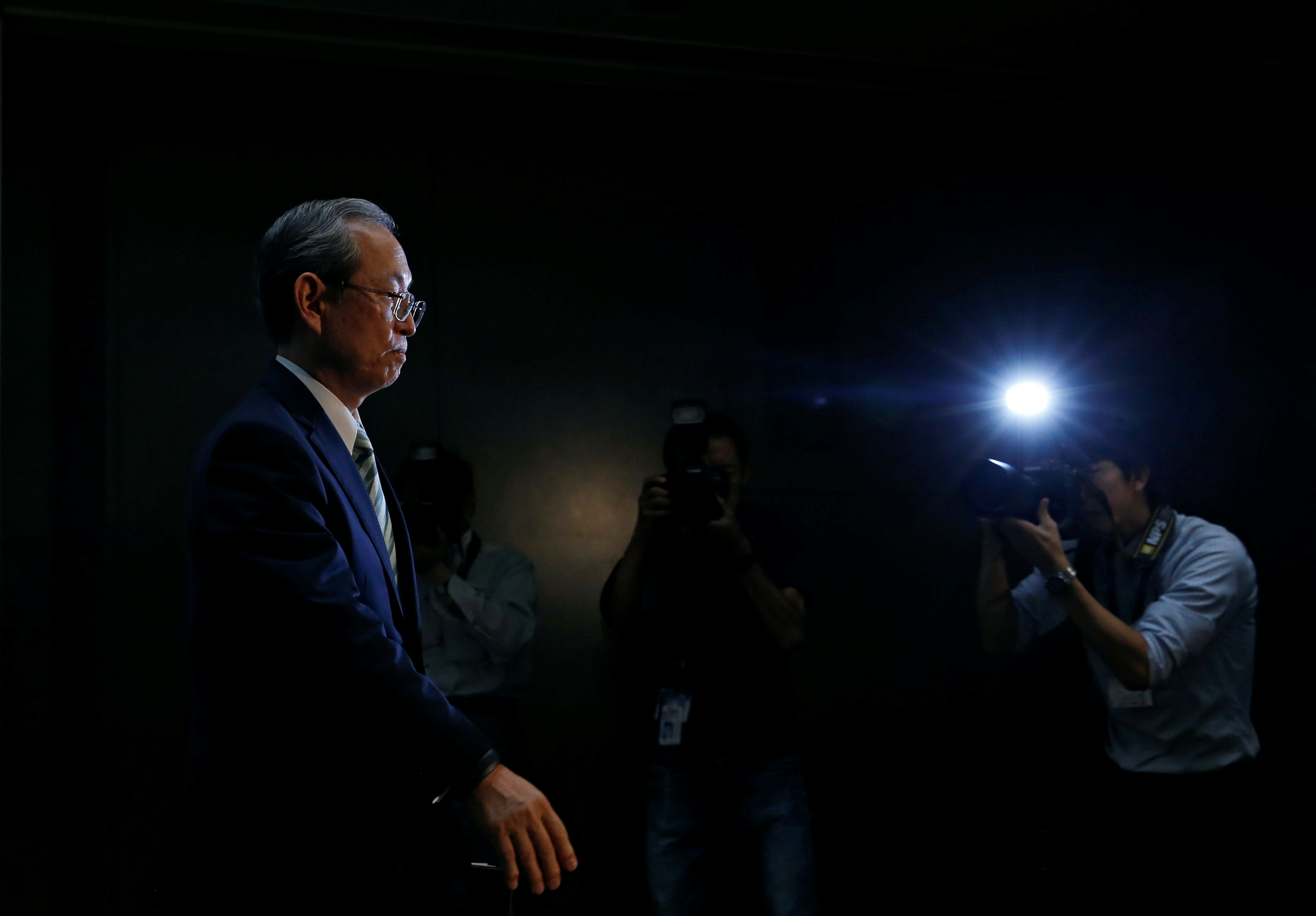 TOKYO, Japan - Go Egami (L), new president of the Incubator Bank of Japan,  shows a stern look during a news conference at the Bank of Japan's  headquarters in Tokyo on July