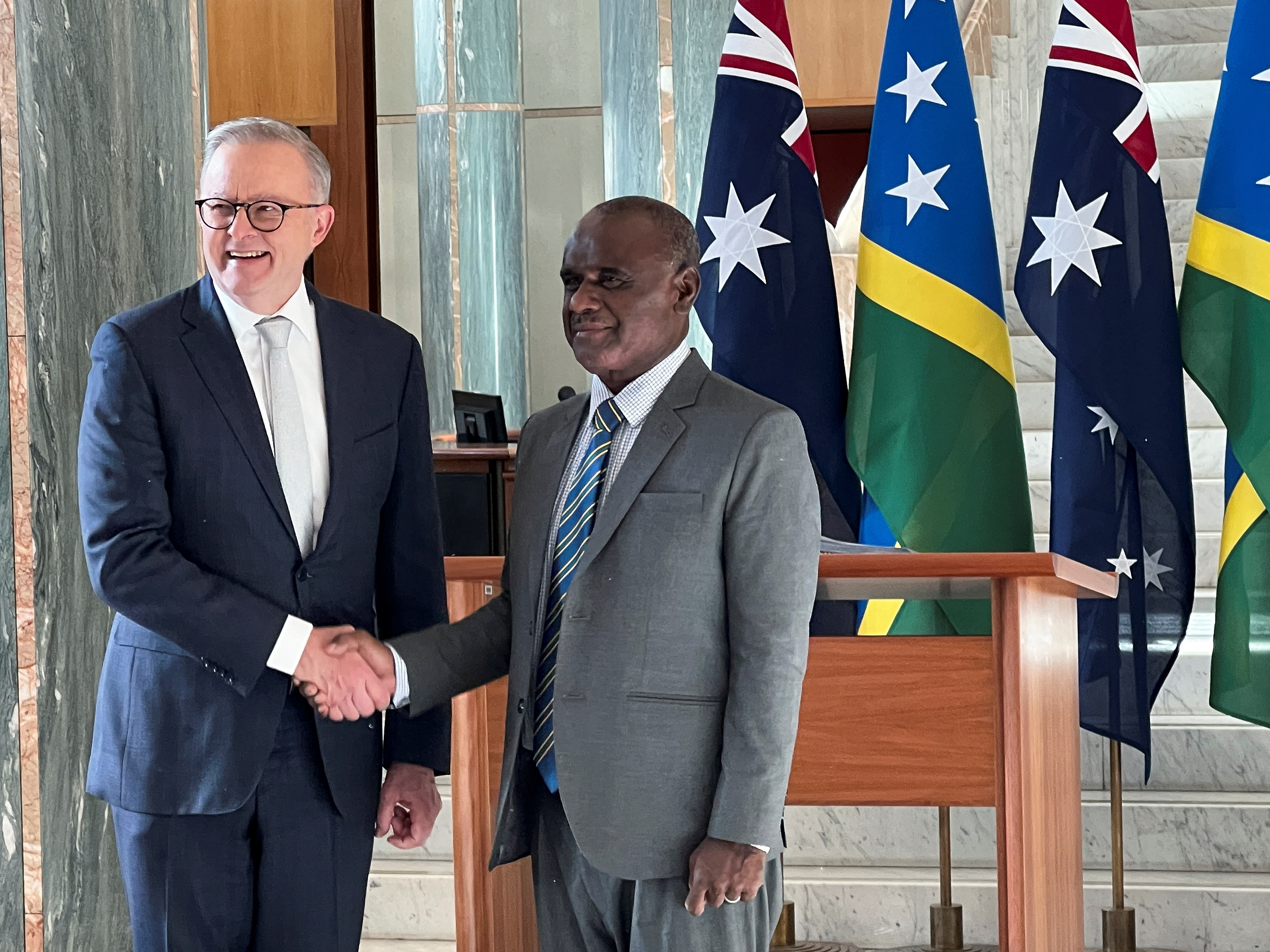 Solomon Islands Prime Minister Jeremiah Manele shakes hands with Australia Prime Minister Anthony Albanese in Australia’s national parliament in Canberra