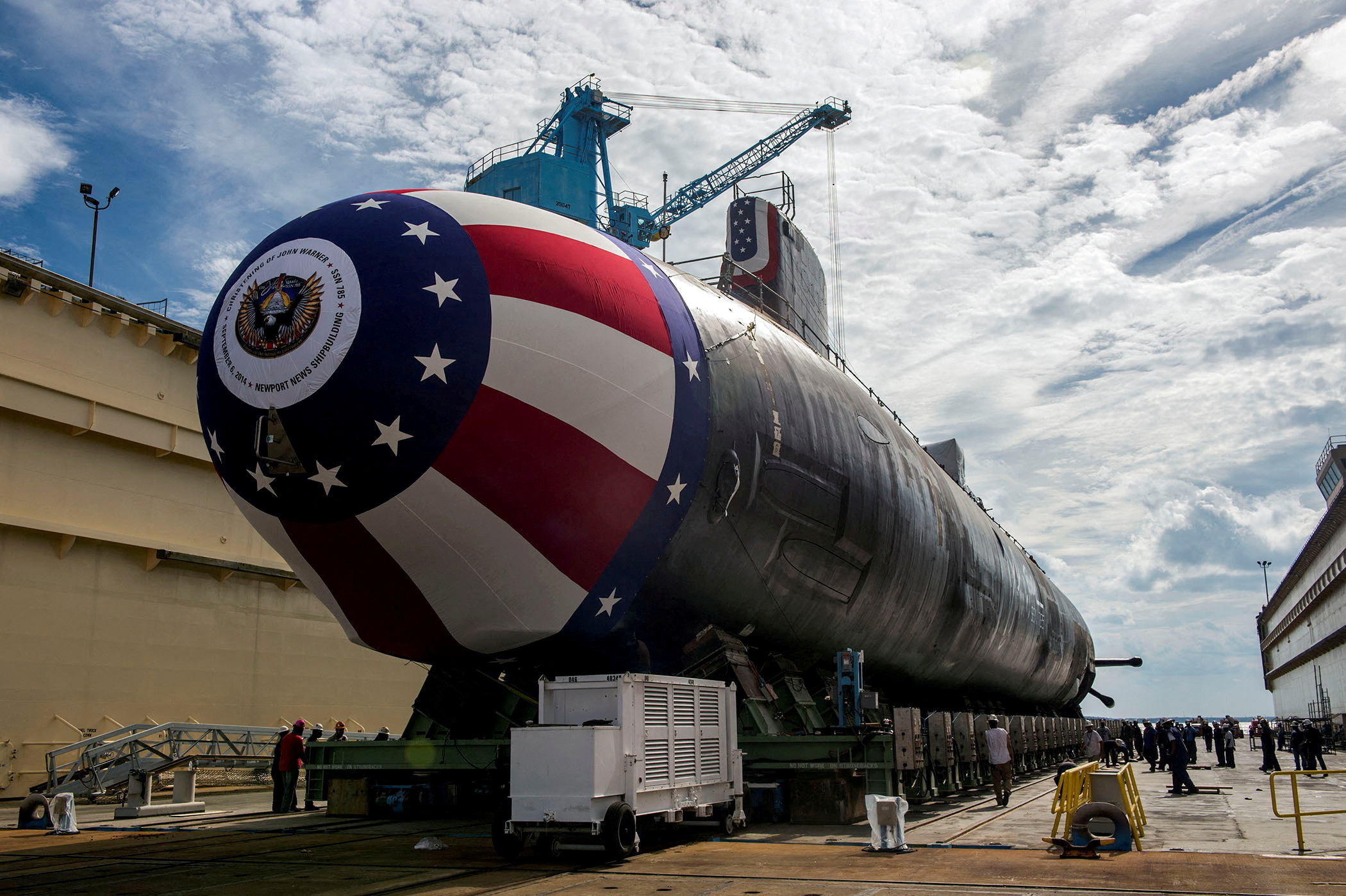 The Virginia-class attack submarine Pre-commissioning Unit John Warner is moved to Newport News Shipbuilding's floating dry dock