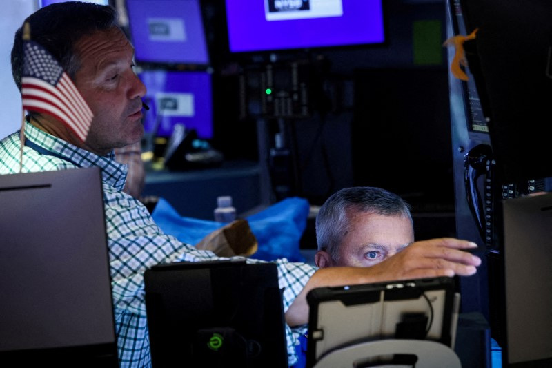 Traders work on the floor of the NYSE in New York