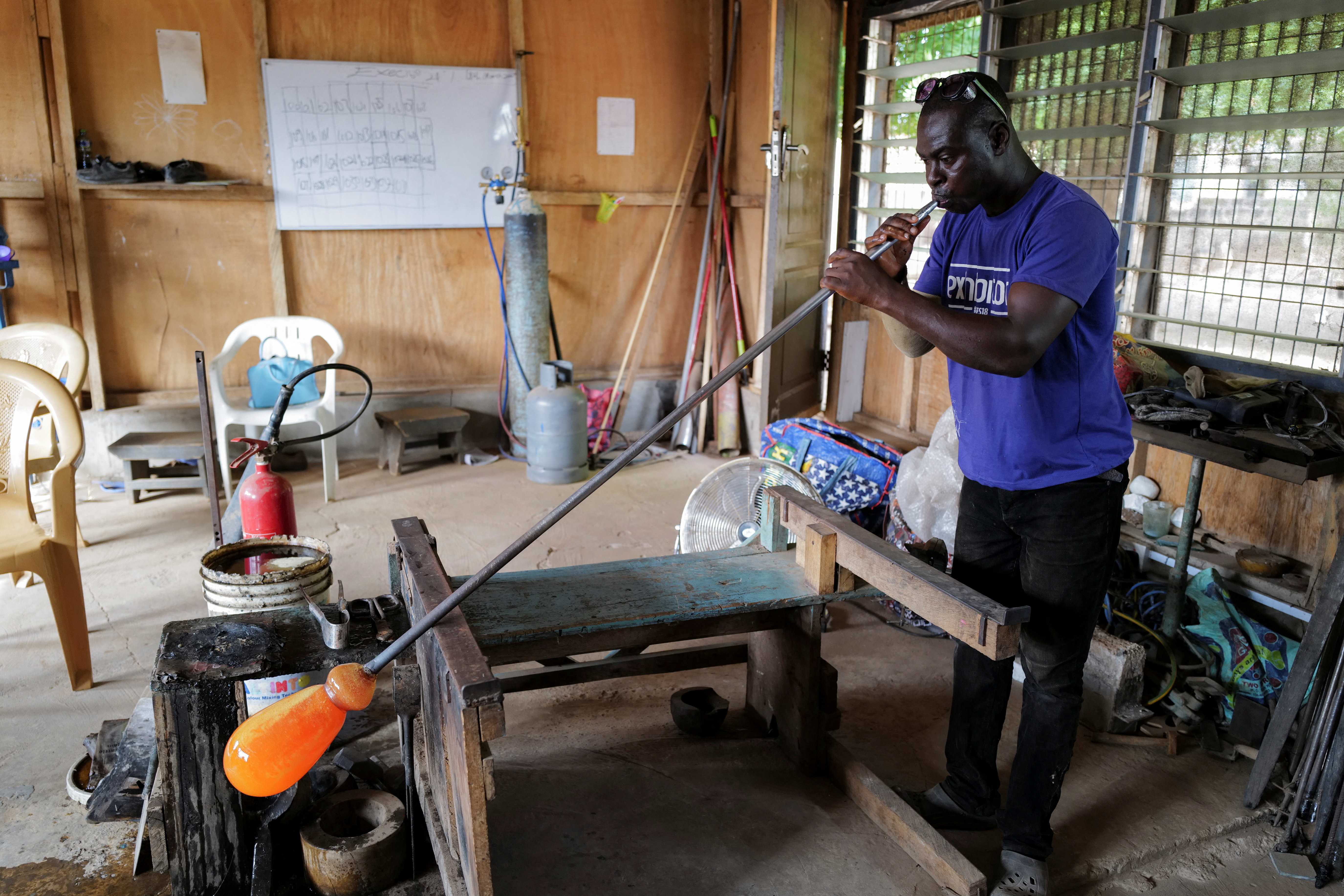 Ghana's only glassblower Michael Tetteh produces glassware at his glassware manufacturing workshop, in Krobo Odumase