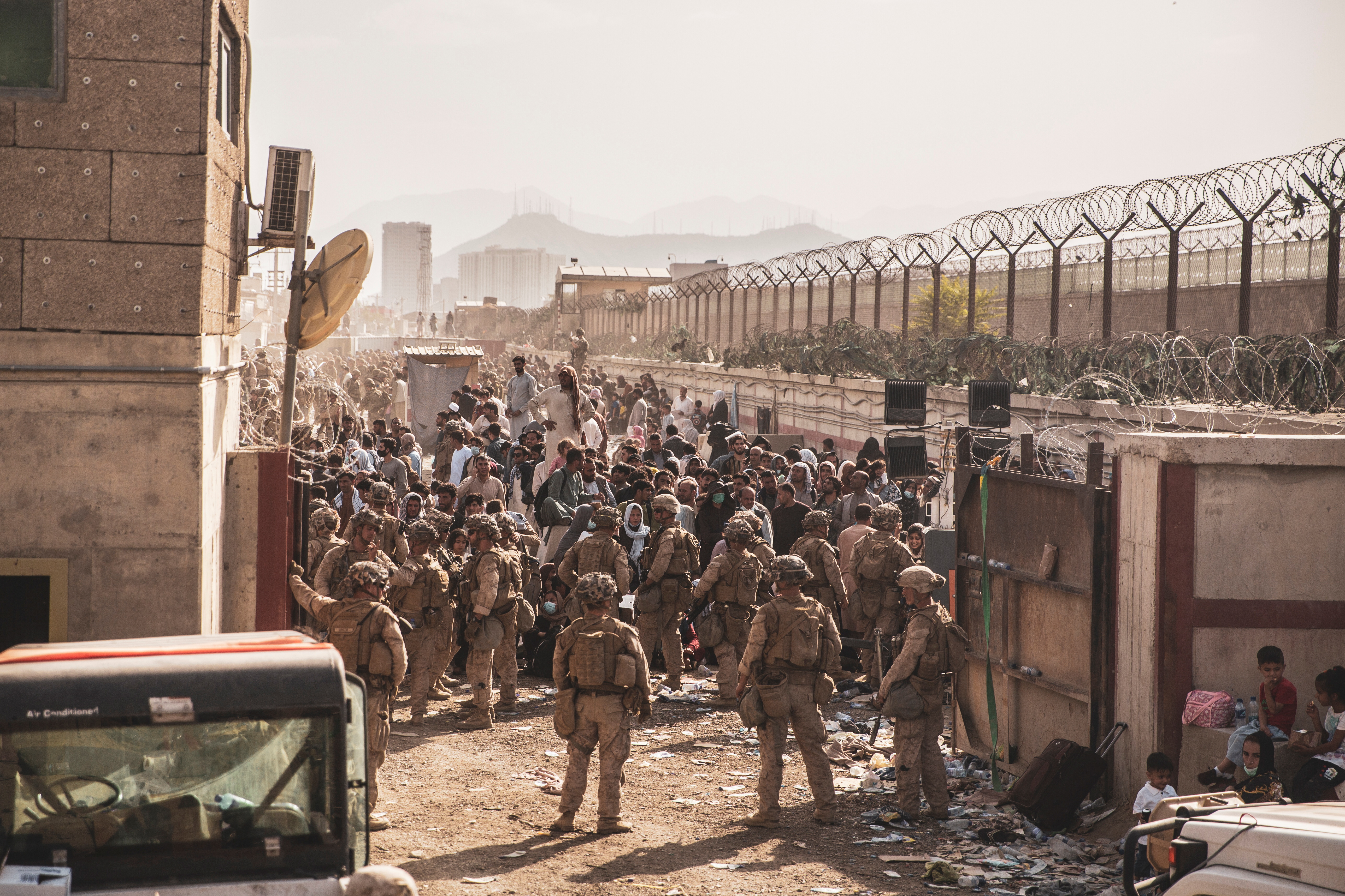 U.S. Marines provide assistance at an Evacuation Control Checkpoint (ECC) during an evacuation at Hamid Karzai International Airport, Afghanistan, August 22, 2021. Picture taken August 22, 2021.  U.S. Marine Corps/Staff Sgt. Victor Mancilla/Handout via REUTERS.