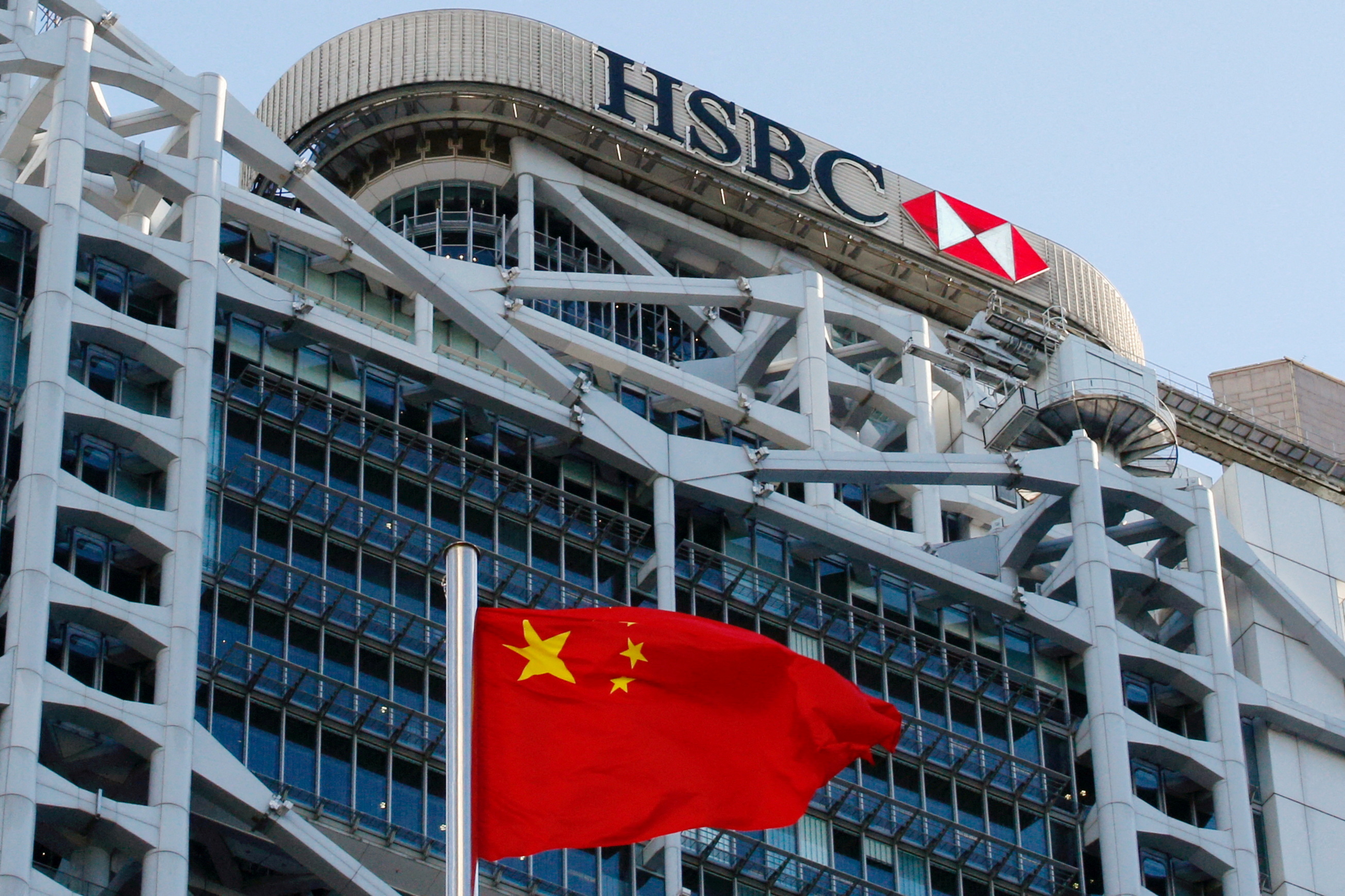 A Chinese national flag flies in front of HSBC headquarters in Hong Kong