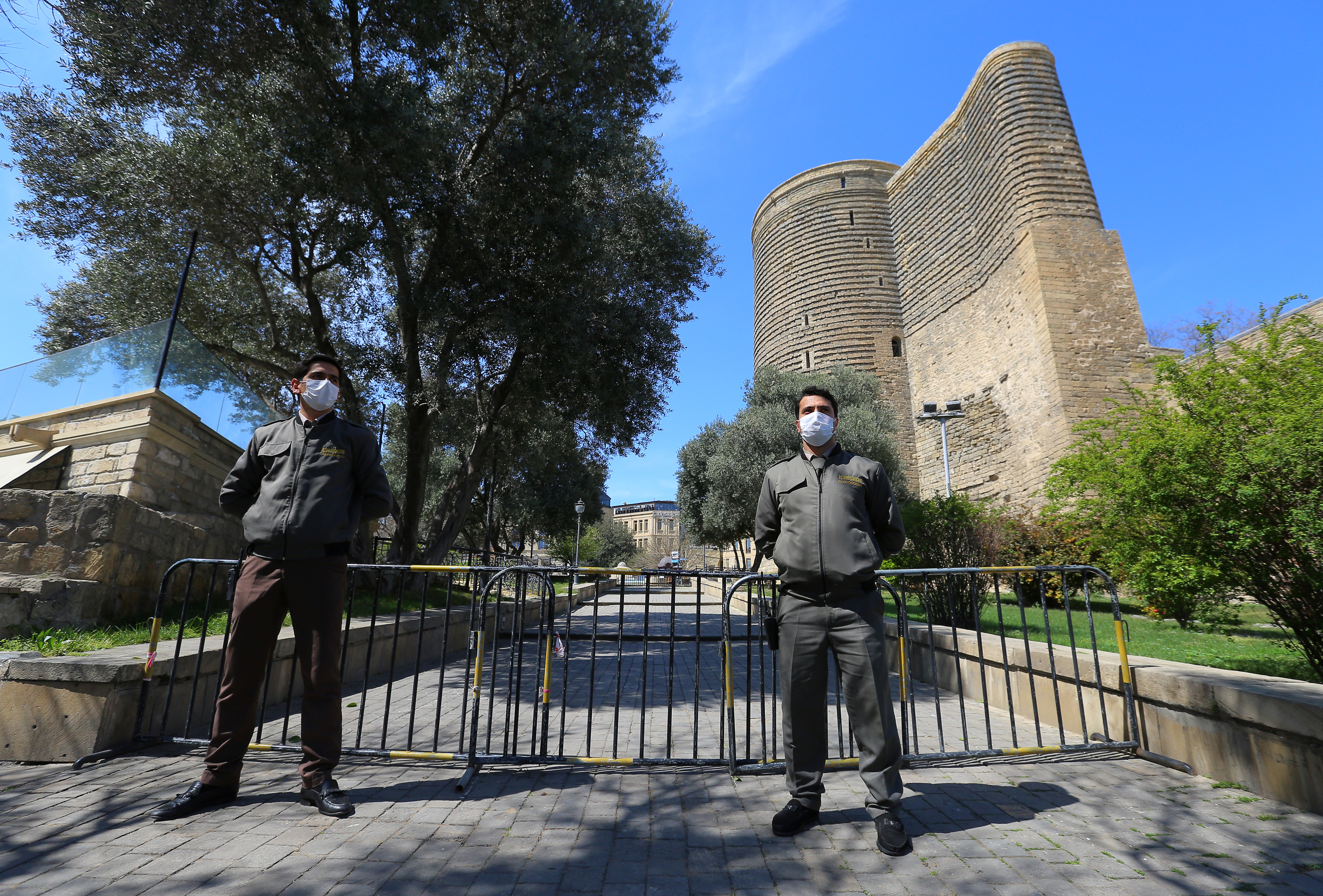 Azeri law enforcement officers stand guard in a street as authorities tightened up measures to prevent the spread of coronavirus disease (COVID-19) in Baku, Azerbaijan April 1, 2020. REUTERS/Aziz Karimov
