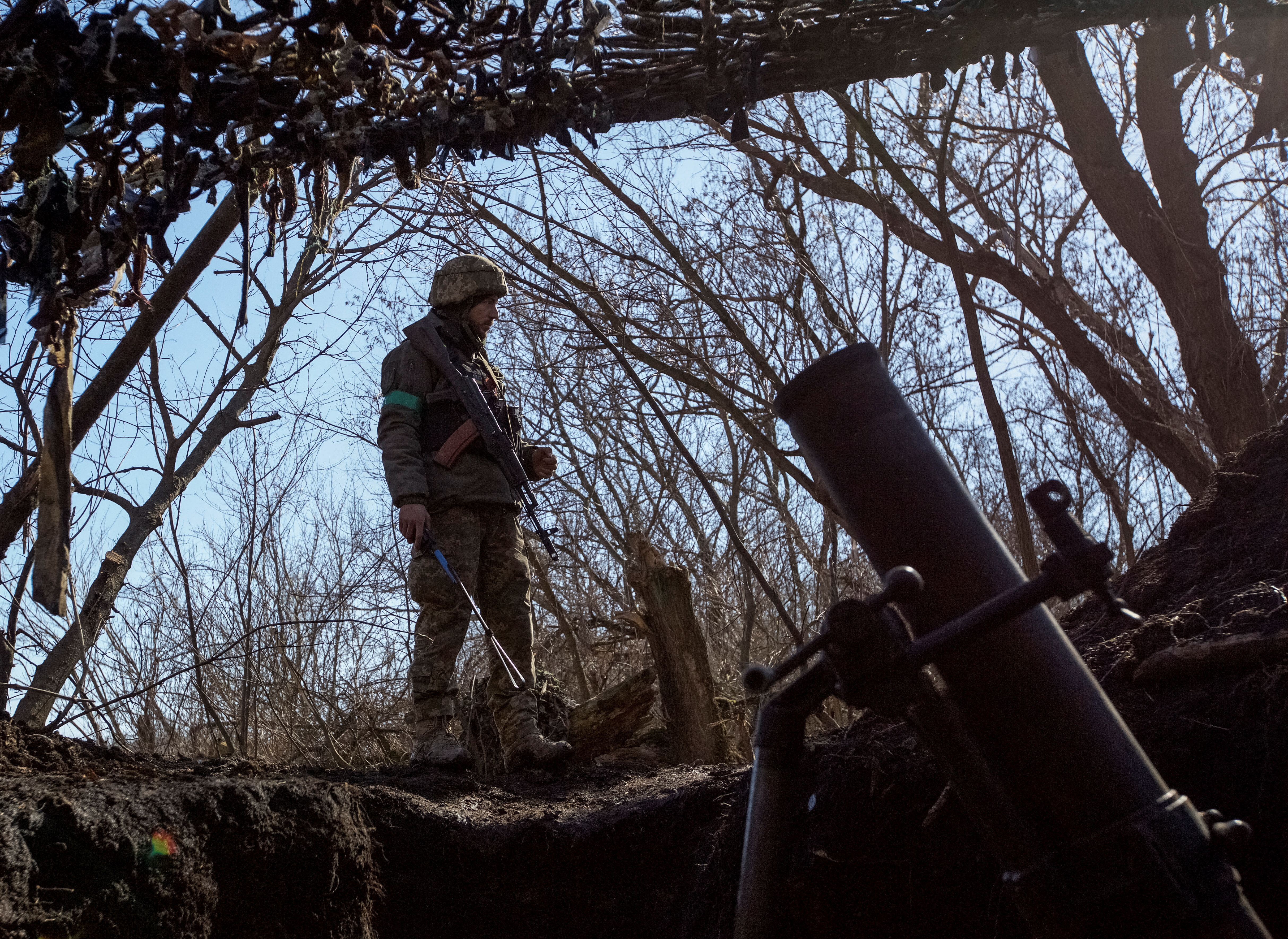 Ukrainian serviceman stands near a mortar on a front line near the front line city of Bakhmut