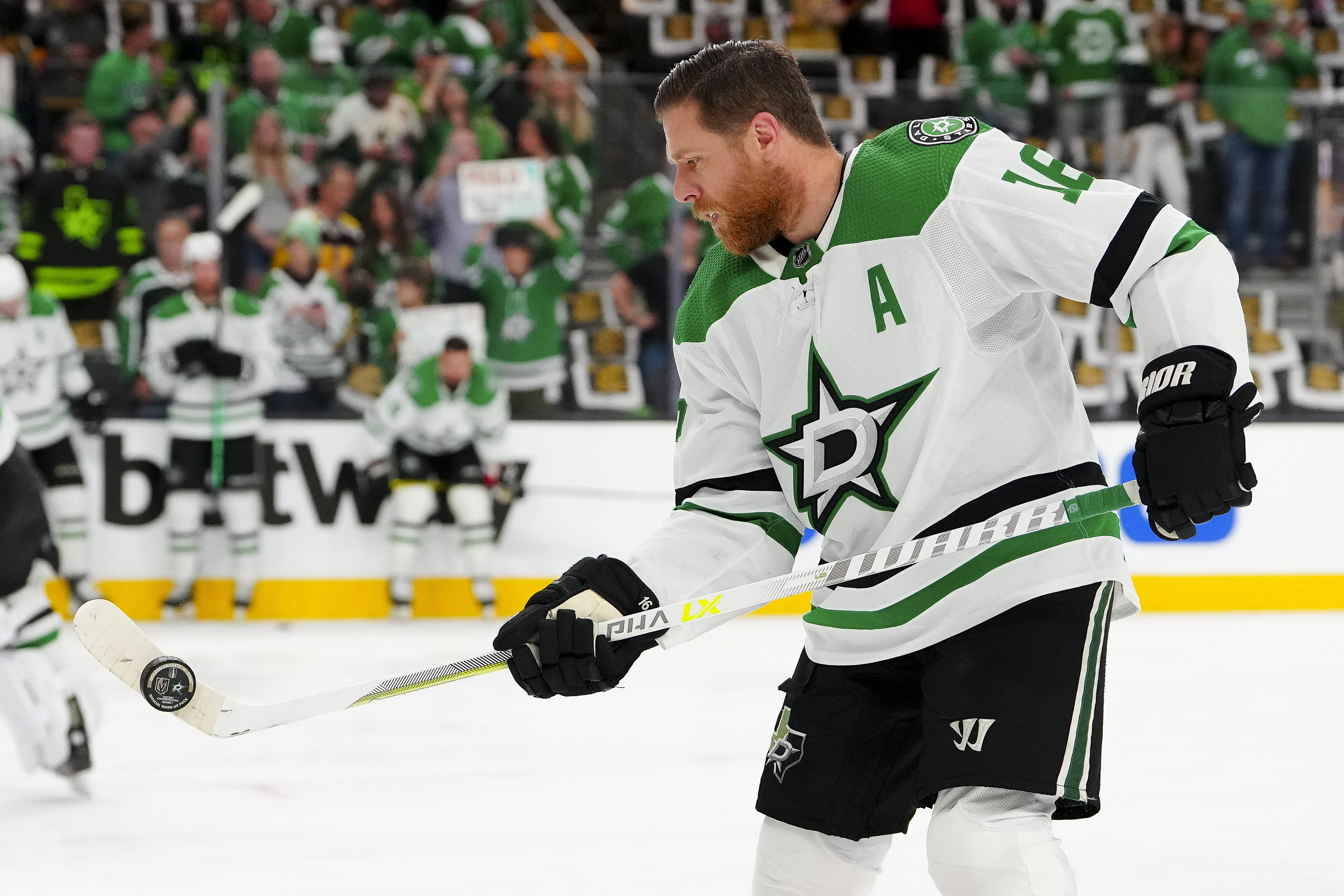 Dallas Stars players skate out for warm ups wearing a special