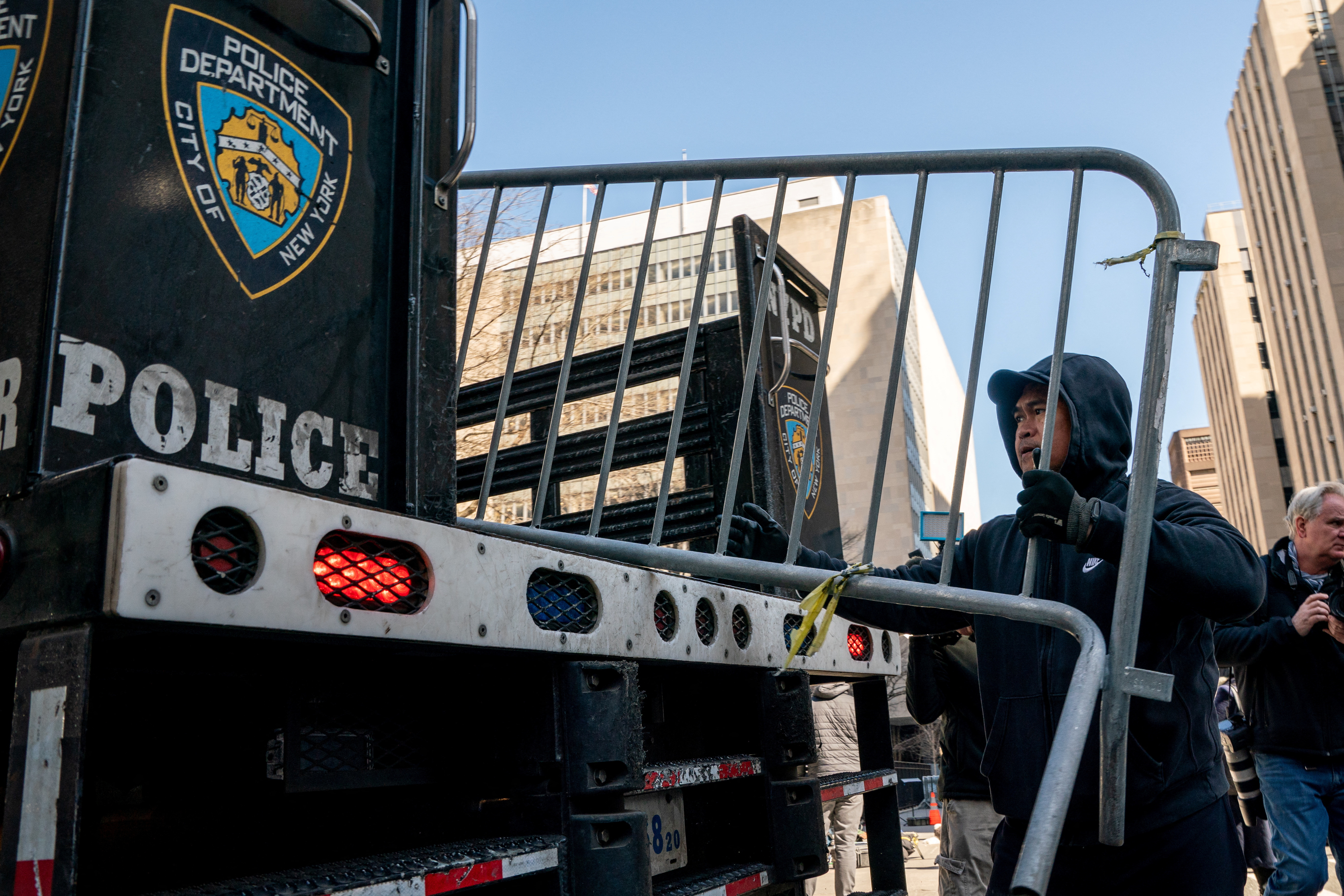 Police officers unload barricades outside Manhattan criminal court as Manhattan District Attorney Bragg continues his investigation into former U.S. President Trump
