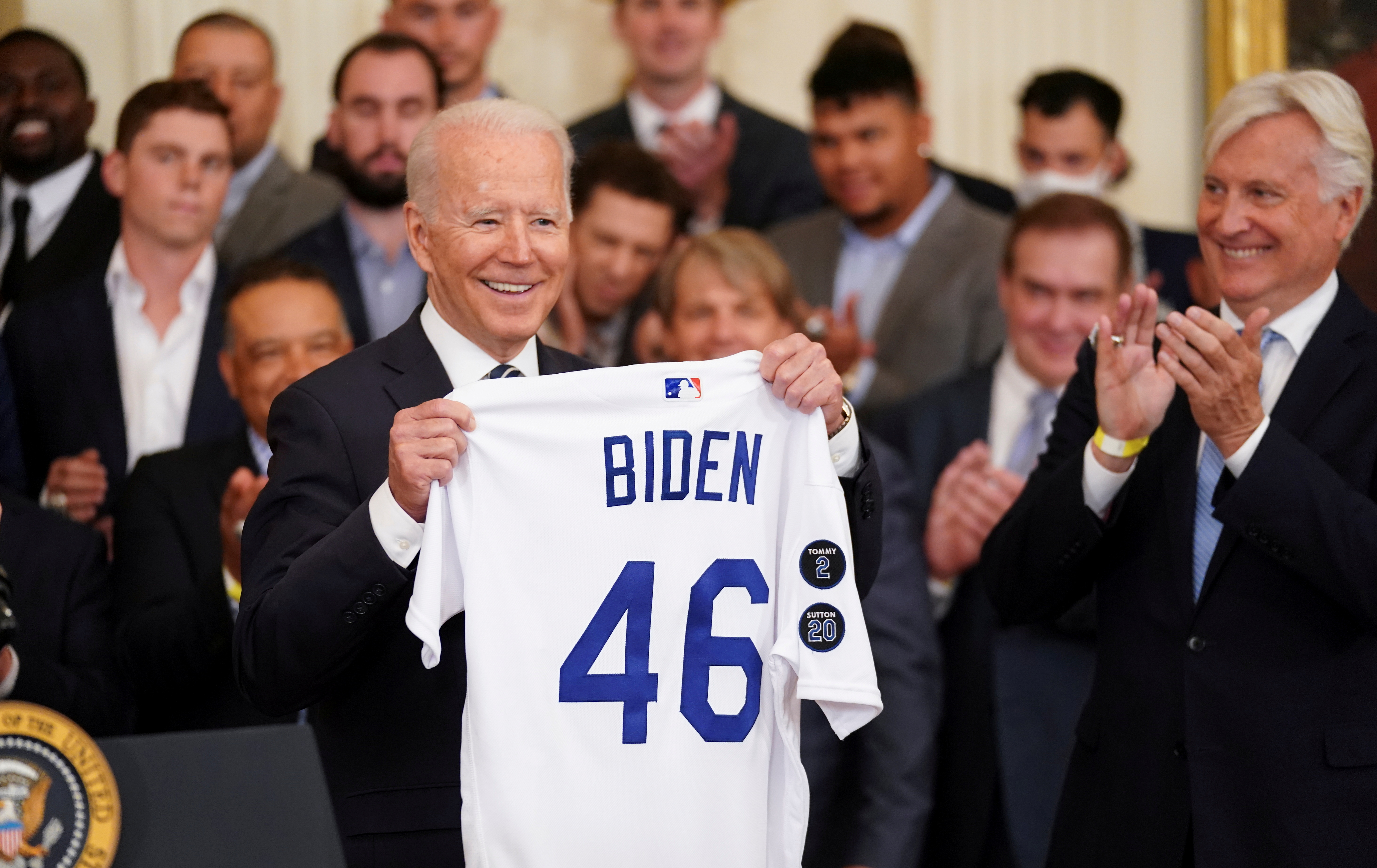 U.S. President Joe Biden holds up team a jersey given to him during a ceremony honoring the members of the 2020 World Series Champion Los Angeles Dodgers in the East Room at the White House in Washington, U.S., July 2, 2021. REUTERS/Kevin Lamarque