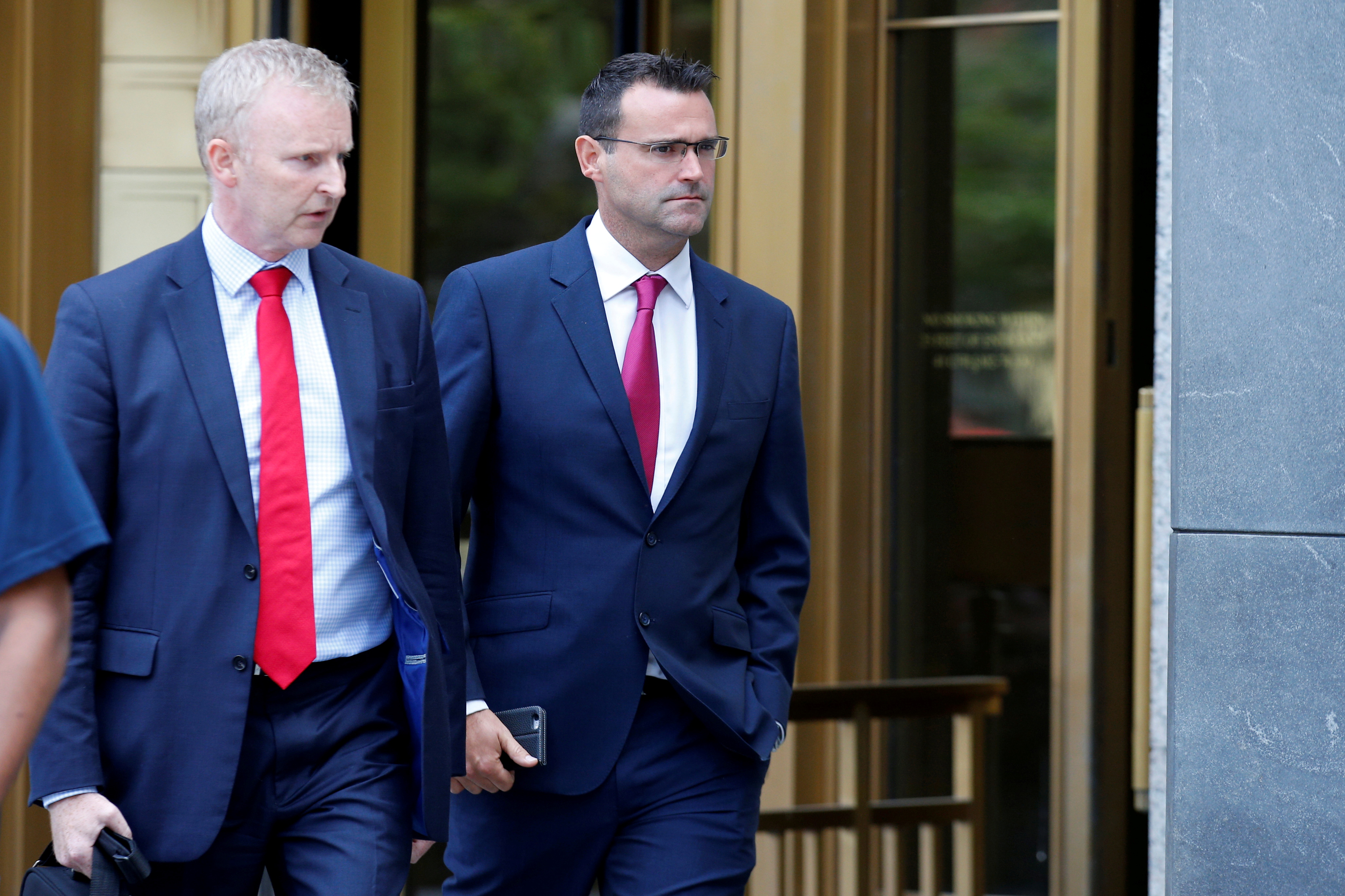 File photo: Richard Usher (right), former London-based trader for JPMorgan Chase & Co, exits the U.S. Federal Court in Manhattan following a hearing for conspiring to rig prices in the foreign exchange market in New York City. REUTERS/Brendan McDermid