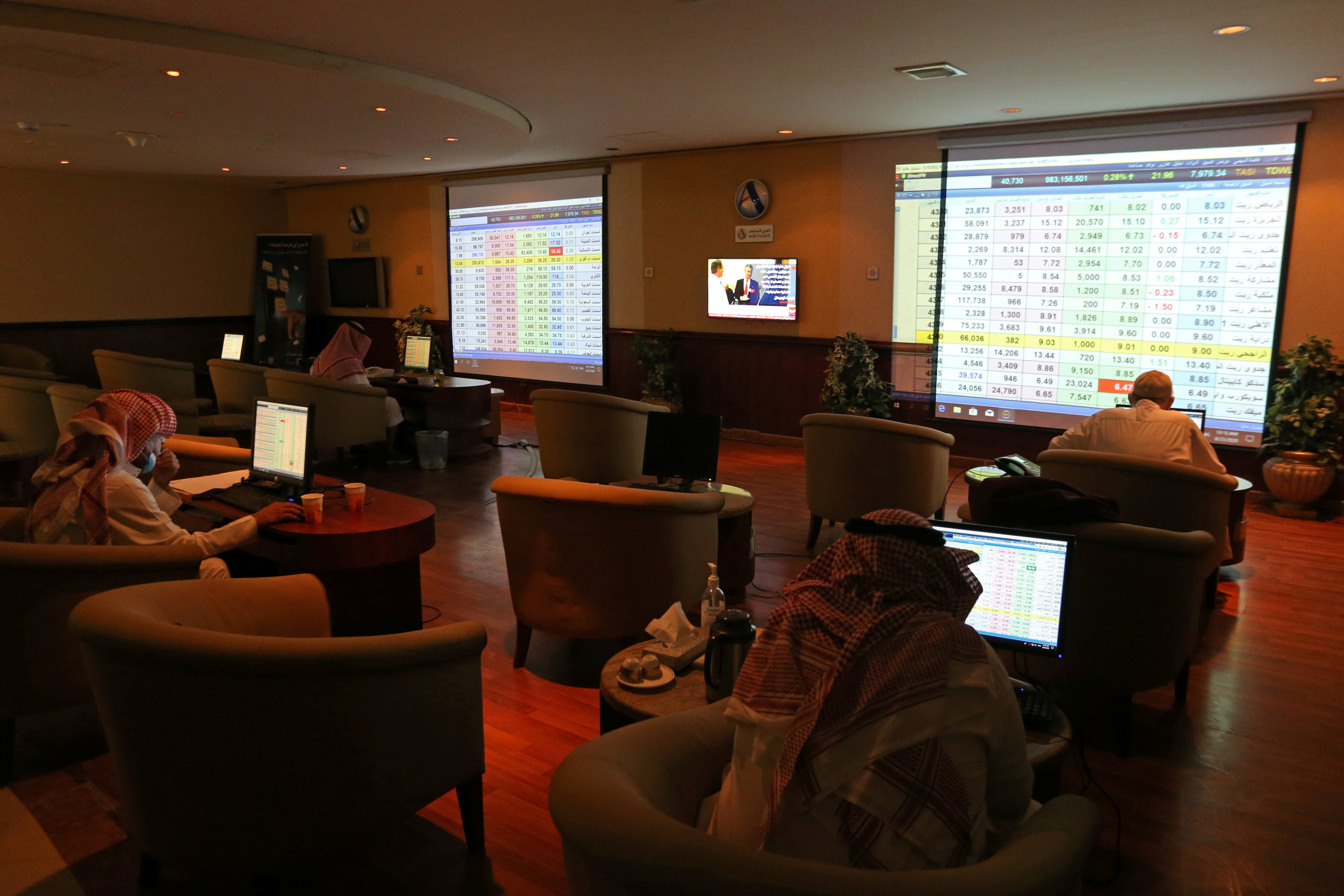 Saudi traders monitor stock information at the Saudi stock market in Riyadh