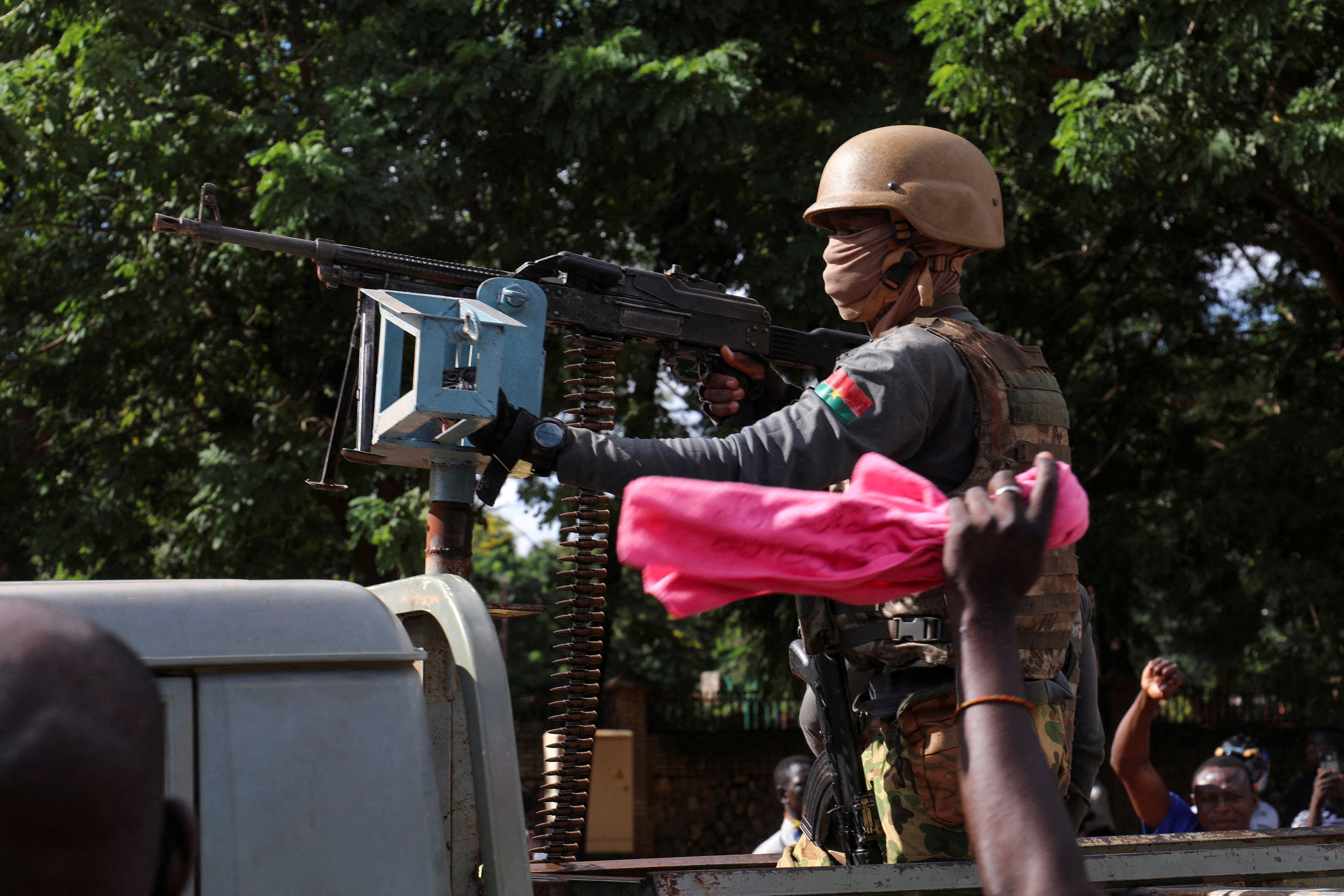 New junta's soldiers stand guard in an armoured vehicle in Ouagadougou