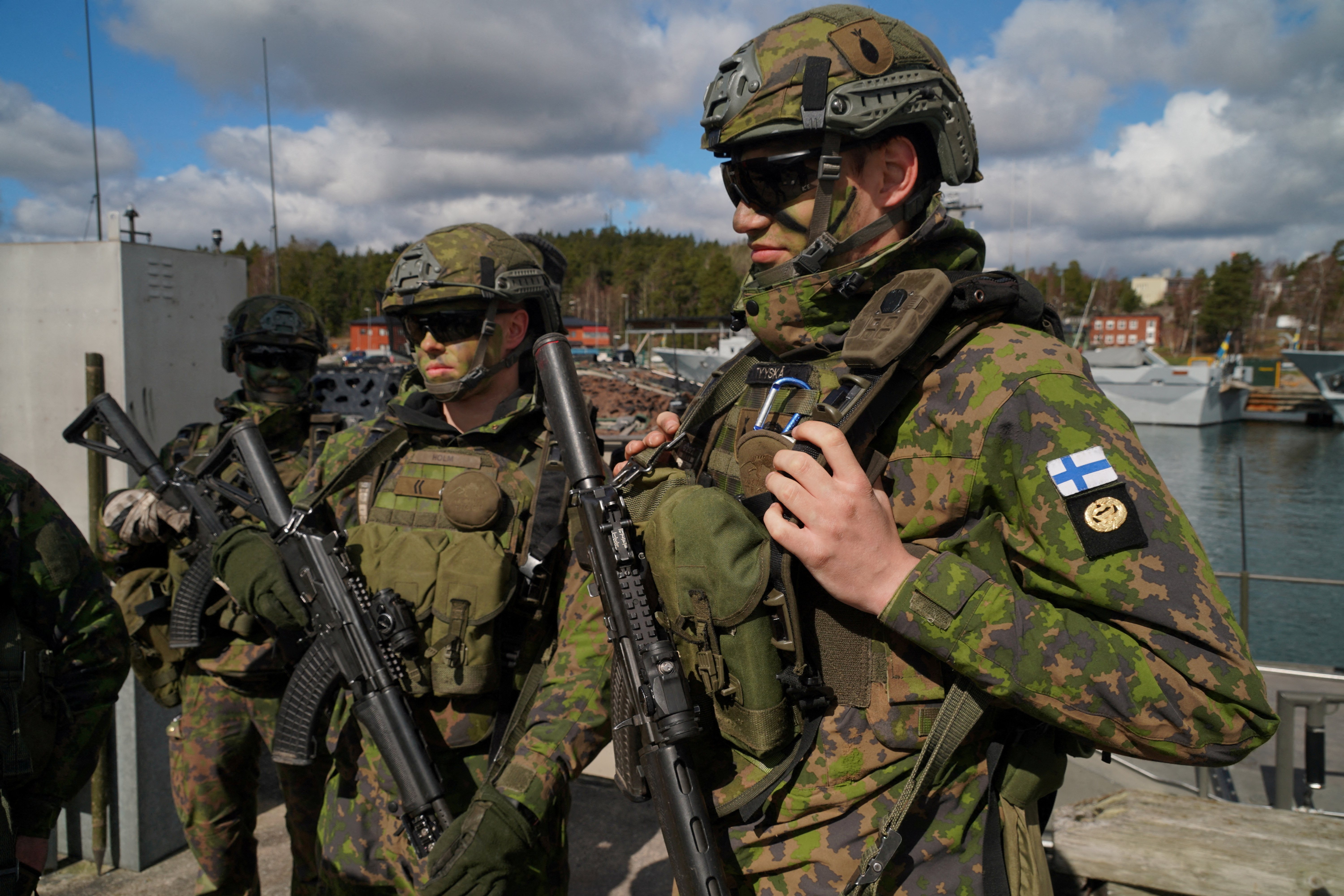 Finnish troops stand on a quay at Berga naval base during Aurora 23 military exercise
