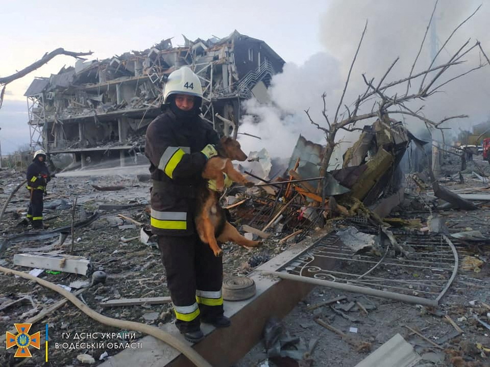 Emergency personnel work near a building damaged after a military strike, in Odesa