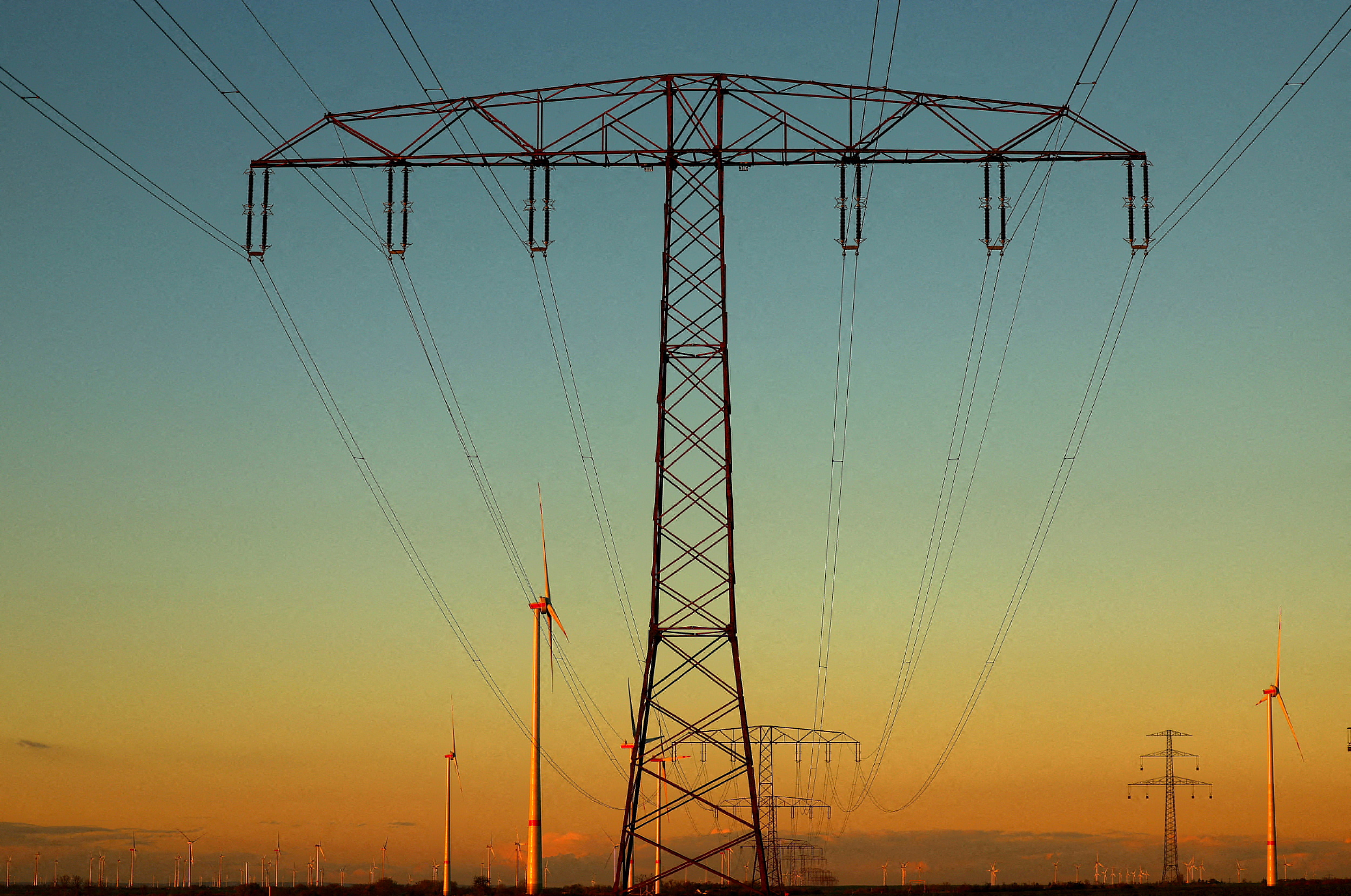 Electrical power pylons next to wind turbines near Weselitz, Germany