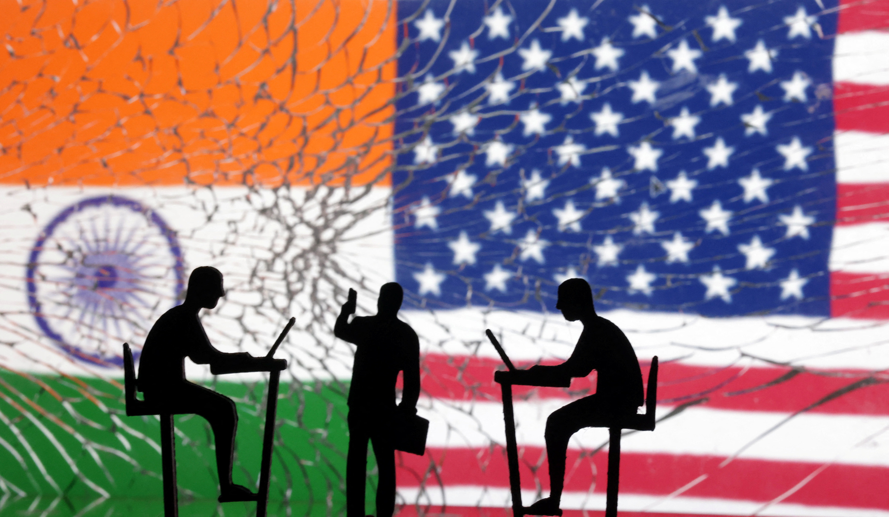 Illustration shows the Indian and U.S. flags and people miniatures