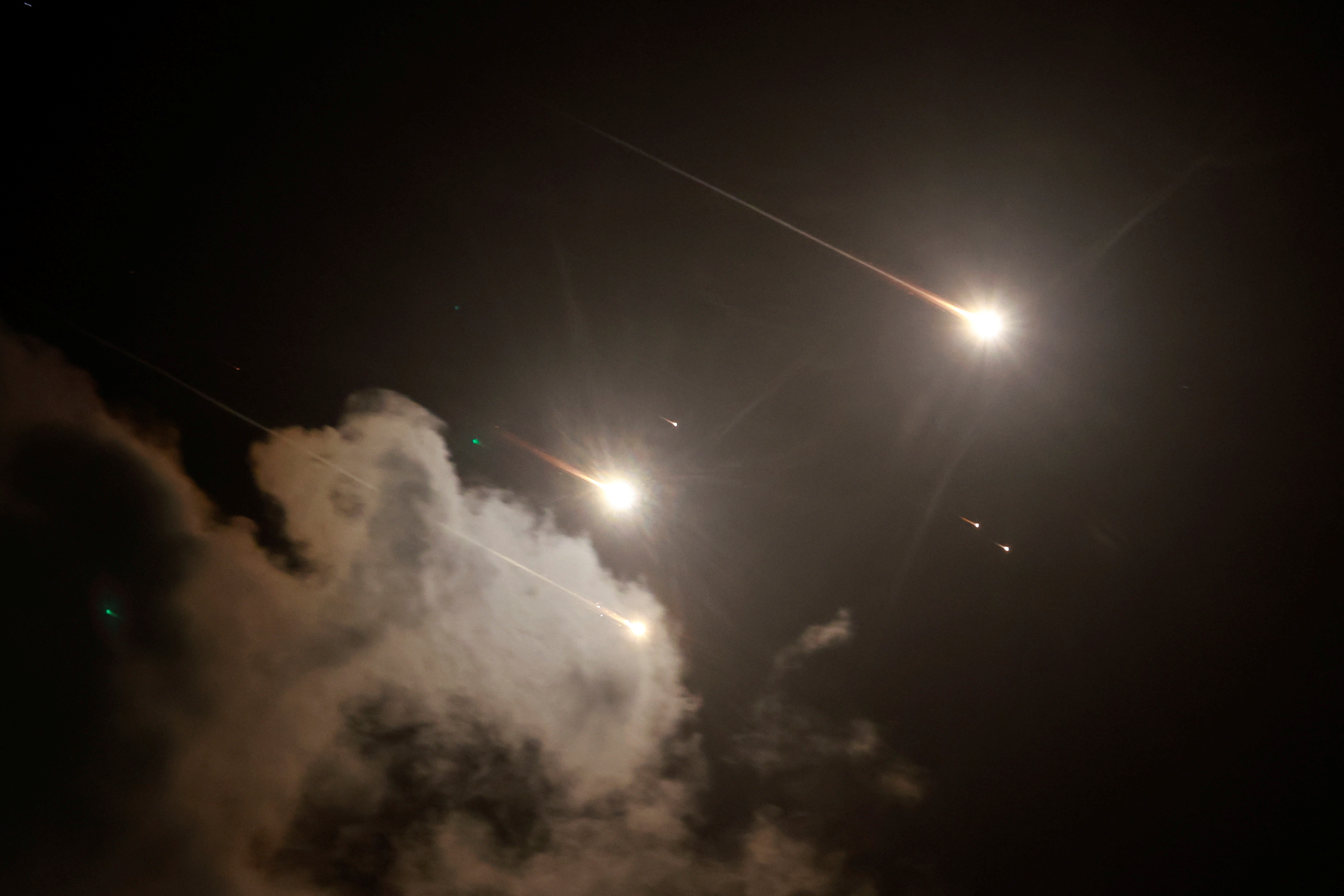 Rockets fly in the sky, amid cross-border hostilities between Hezbollah and Israel, as seen from Tel Aviv