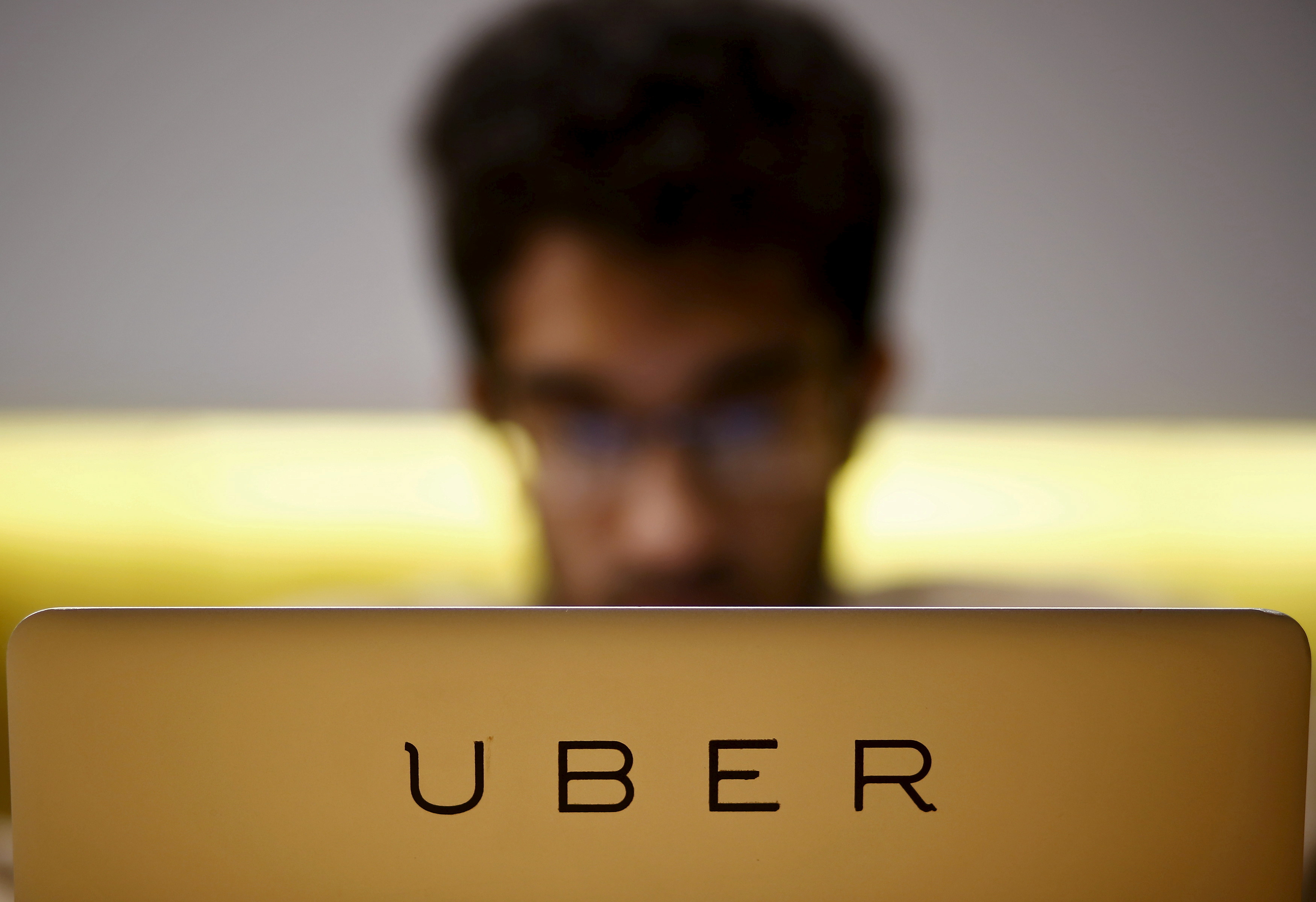 Employee works inside the office of U.S. online cab-hailing company Uber on the outskirts of New Delhi