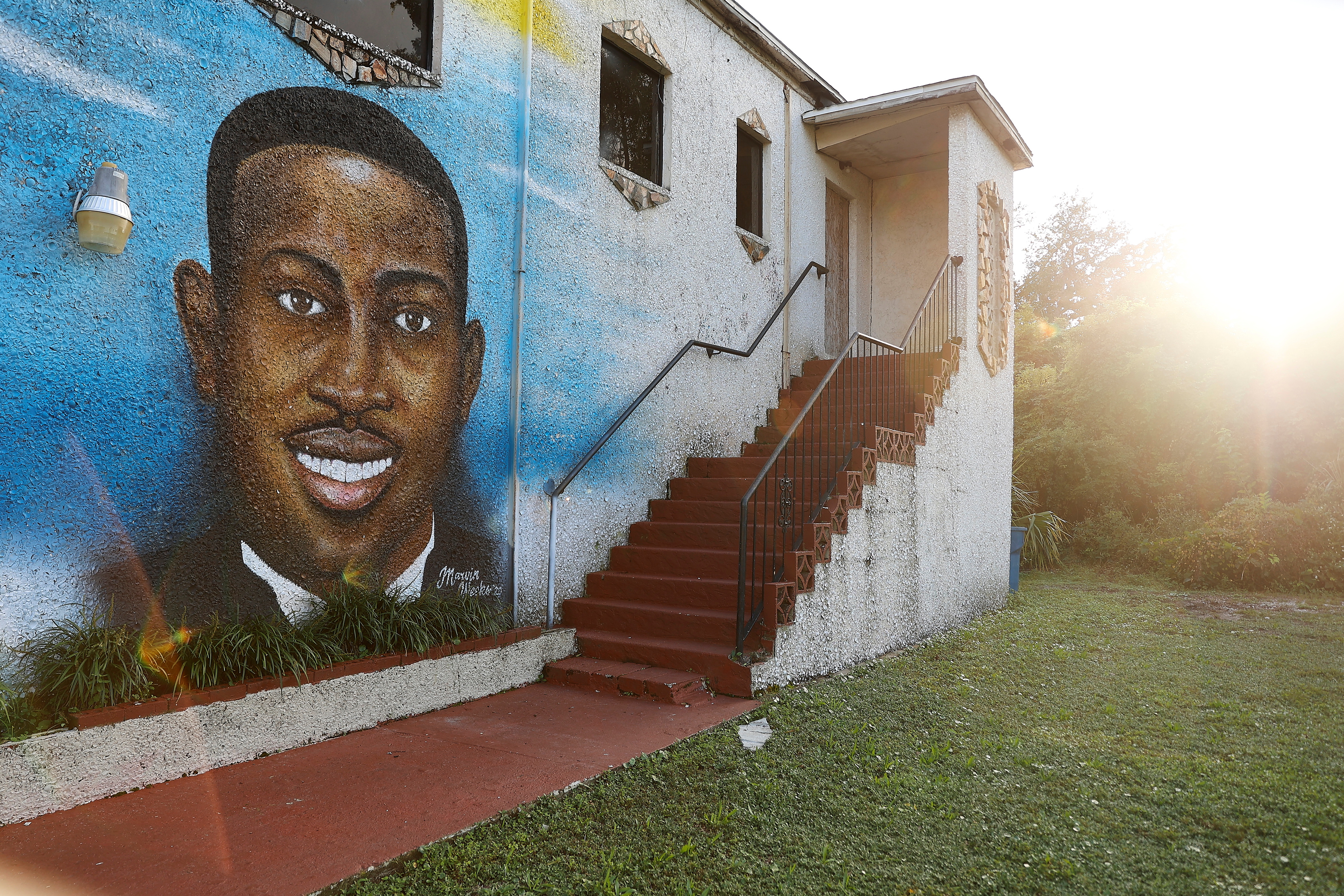 A mural of Ahmaud Arbery is painted on the side of The Brunswick African American Cultural Center in downtown Brunswick, Georgia, U.S. October 11, 2021.  REUTERS/ Christopher Aluka Berry