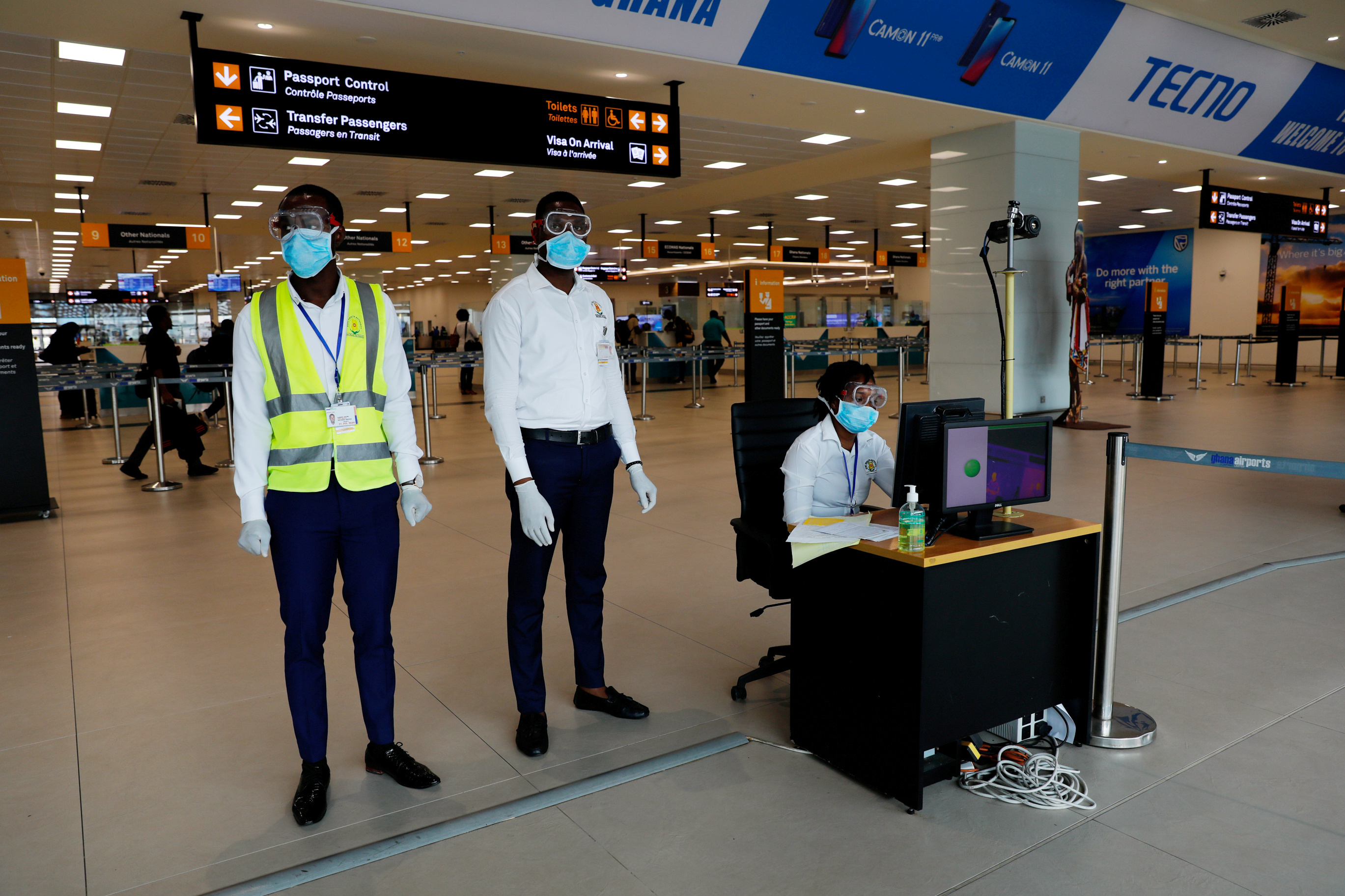 A health worker monitors a screen showing a thermal scan to check the temperatures of passengers at the Kotoka International Airport in Accra