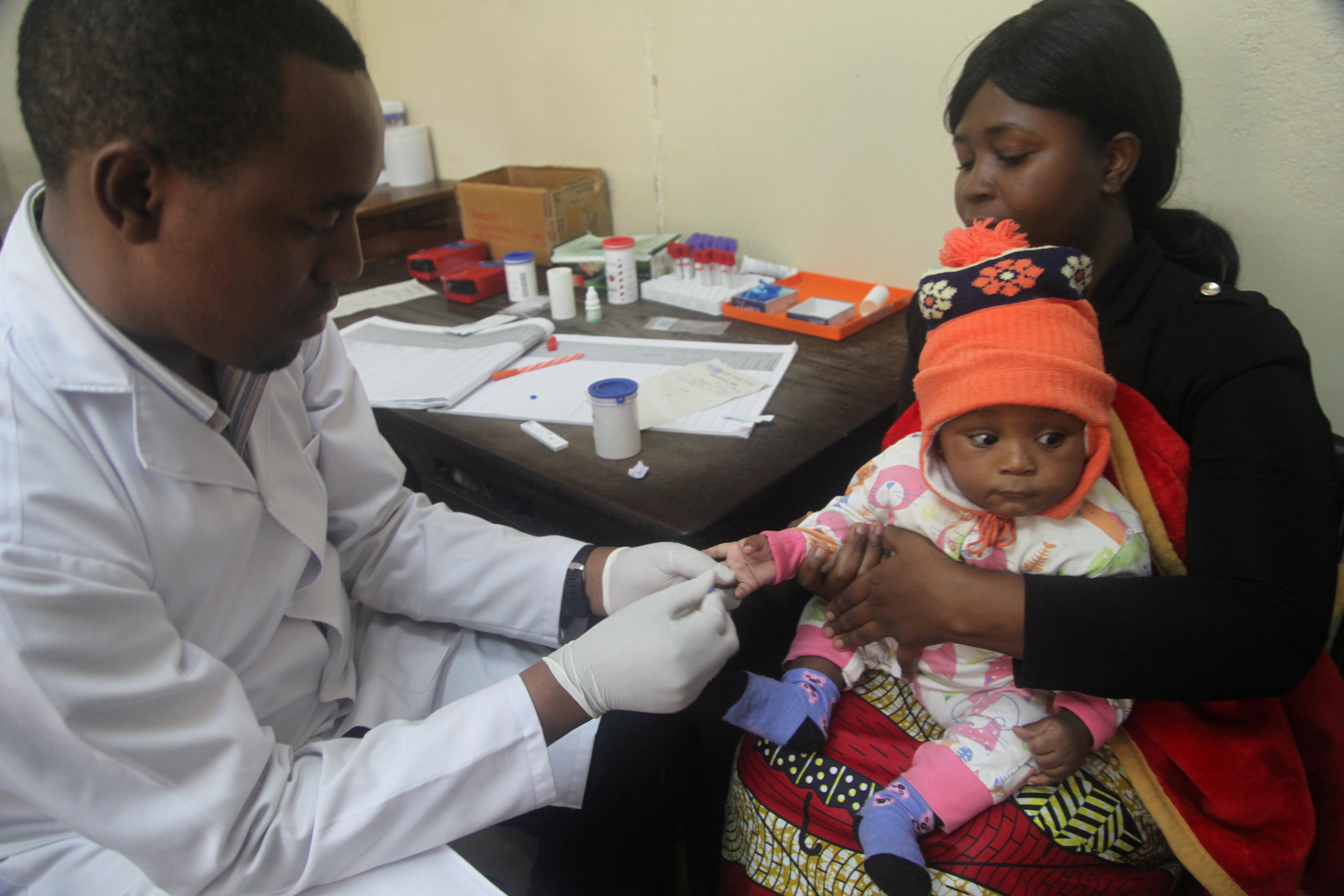 A doctor tests a child for malaria at the Ithani-Asheri Hospital in Arusha, Tanzania
