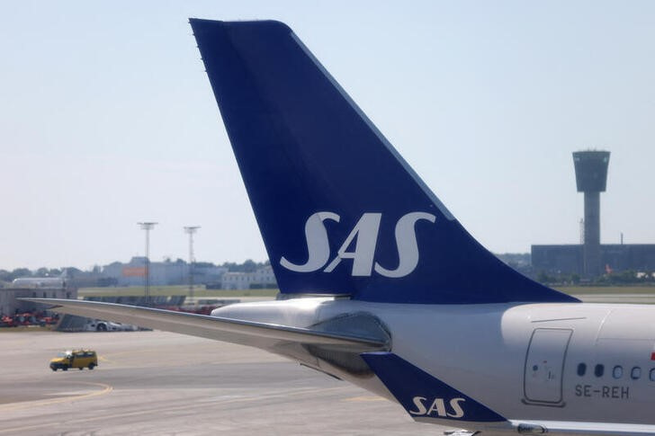 The tail fin of Scandinavian Airlines (SAS) airplane parked on the tarmac at Copenhagen Airport Kastrup in Copenhagen