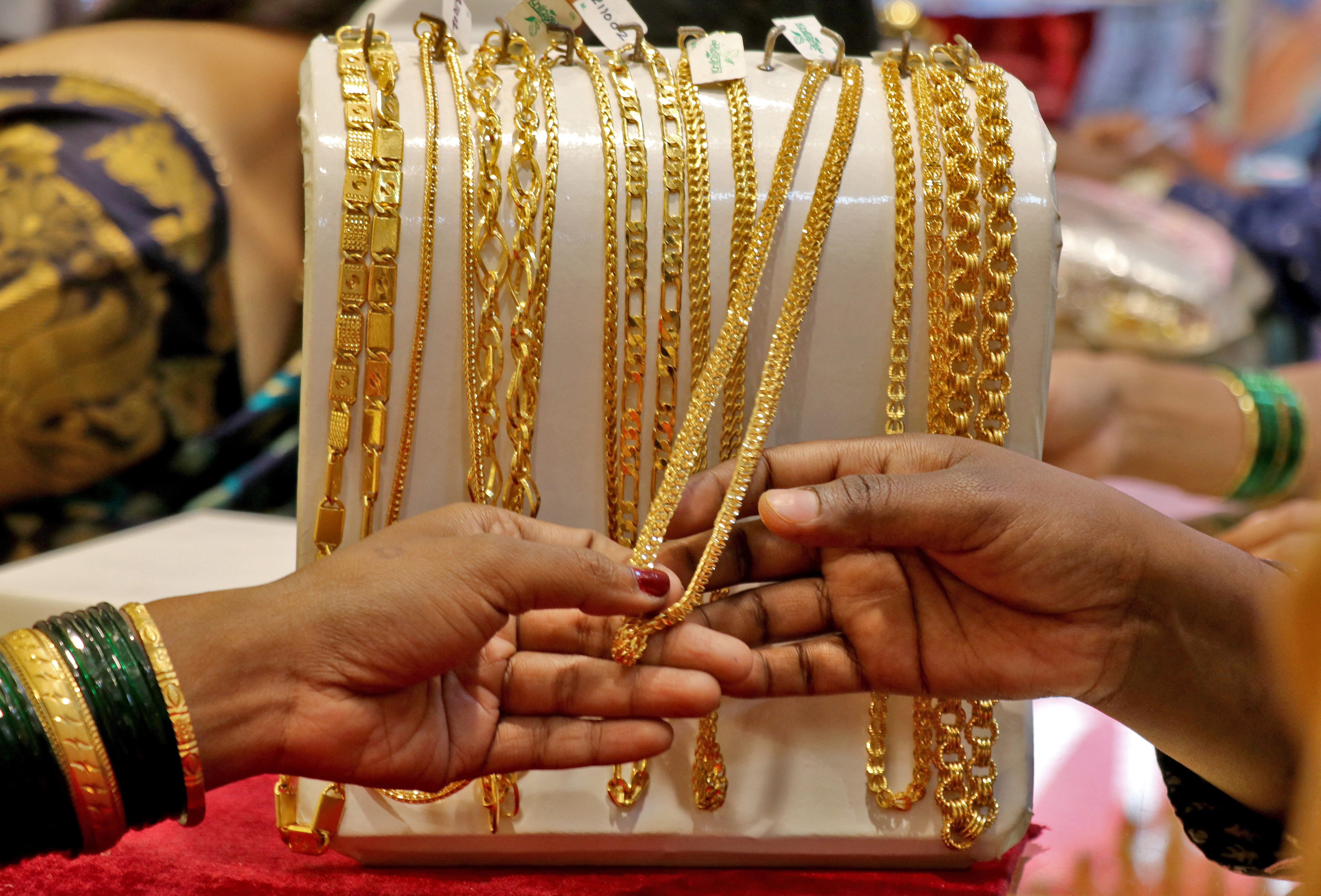 Customers check ornaments at a jewellery showroom during Dhanteras, in Mumbai