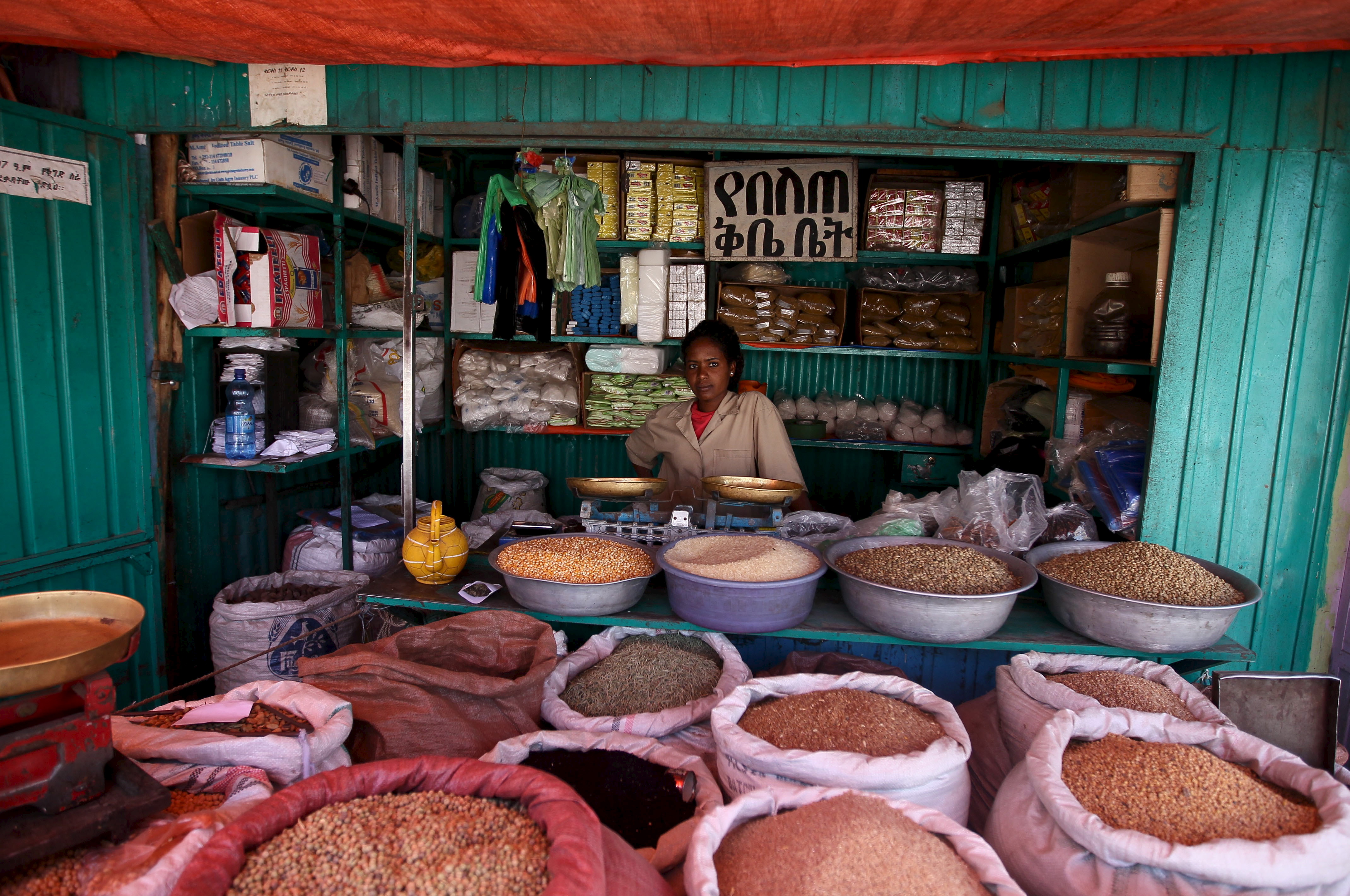 A shop owner poses for a photograph at the Mercato market in Addis Ababa
