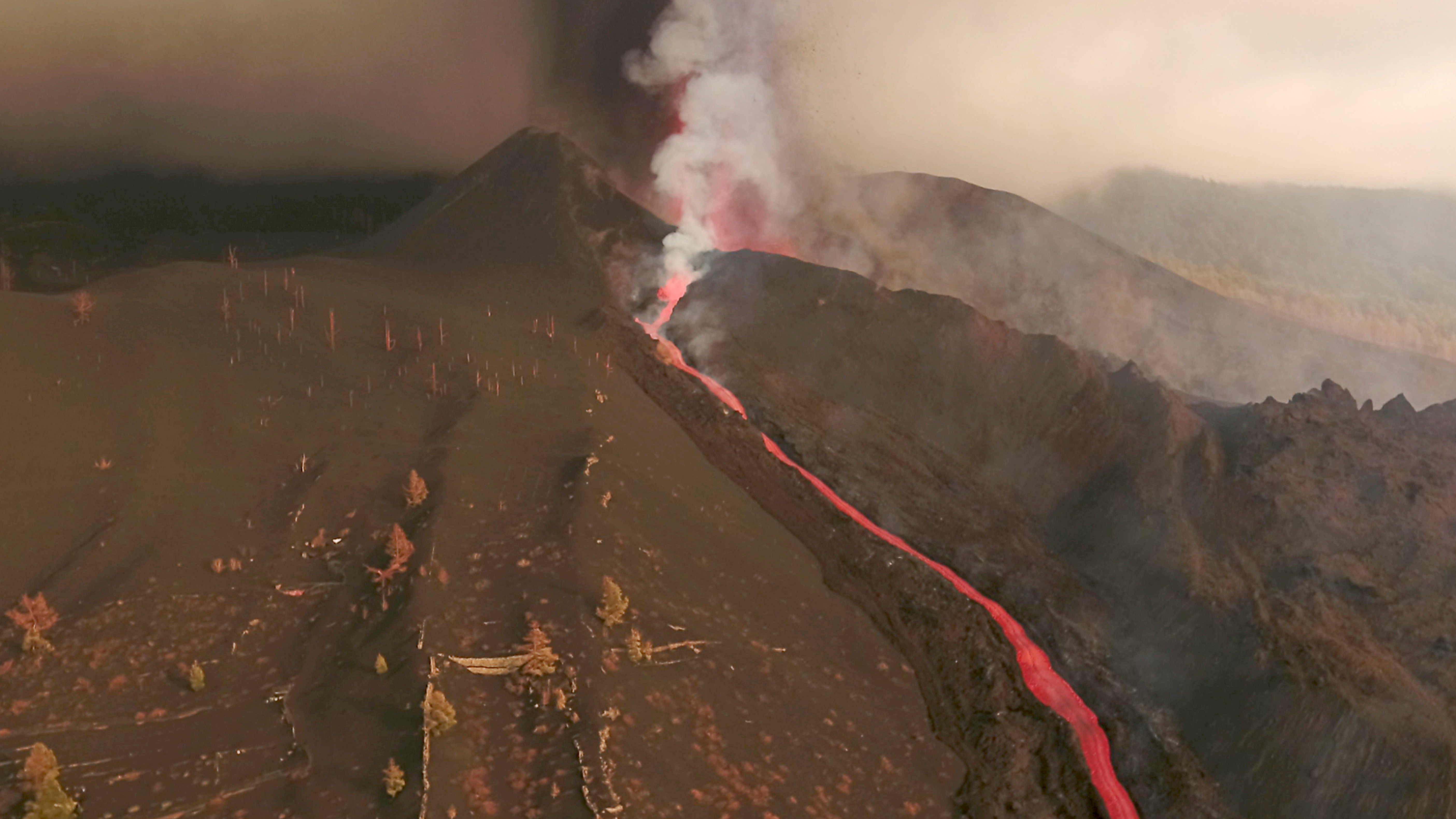 A screengrab from drone footage shows lava flowing following the eruption of a volcano in the Cumbre Vieja park, on the Canary Island of La Palma, Spain September 26, 2021. REUTERS TV via REUTERS