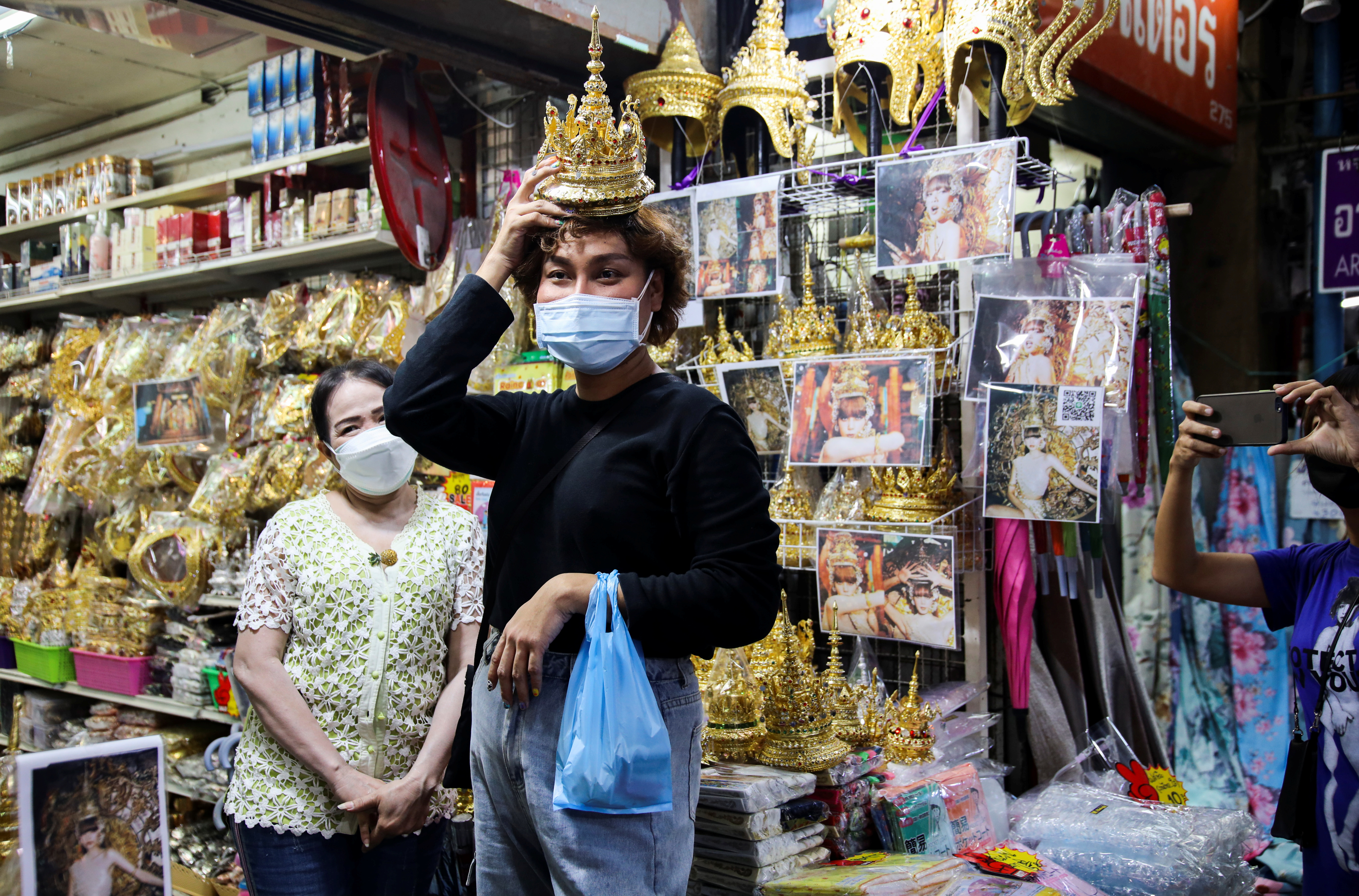 Costumer looks for Thai traditional costume head gear similar to one wore by  K-pop singer Lisa at a shop selling merchandise items in Bangkok