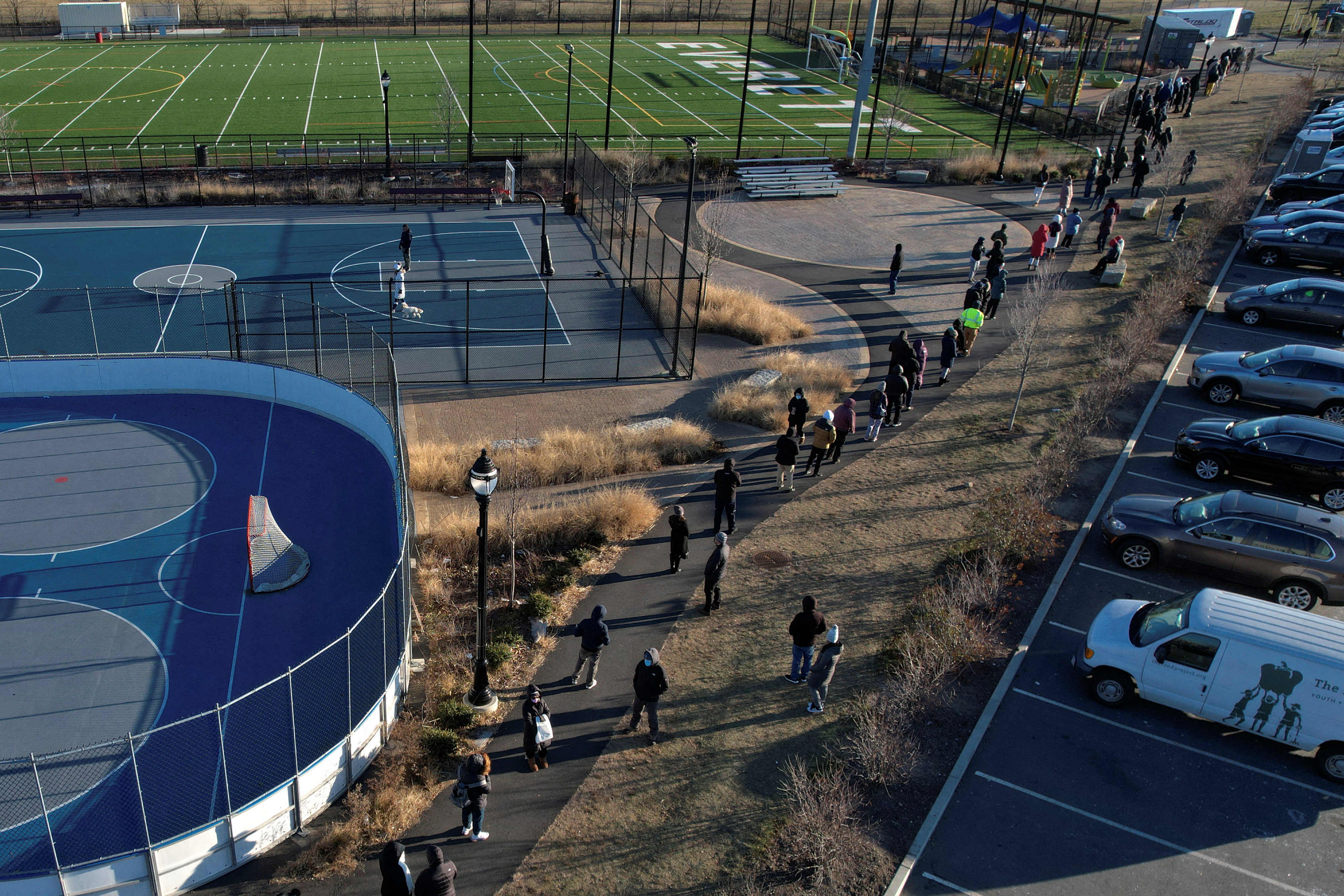 People line up in cold winter temperatures to be tested for the coronavirus disease (COVID-19) in Everett, Massachusetts, U.S., January 4, 2022. Picture taken with a drone. REUTERS/Brian Snyder