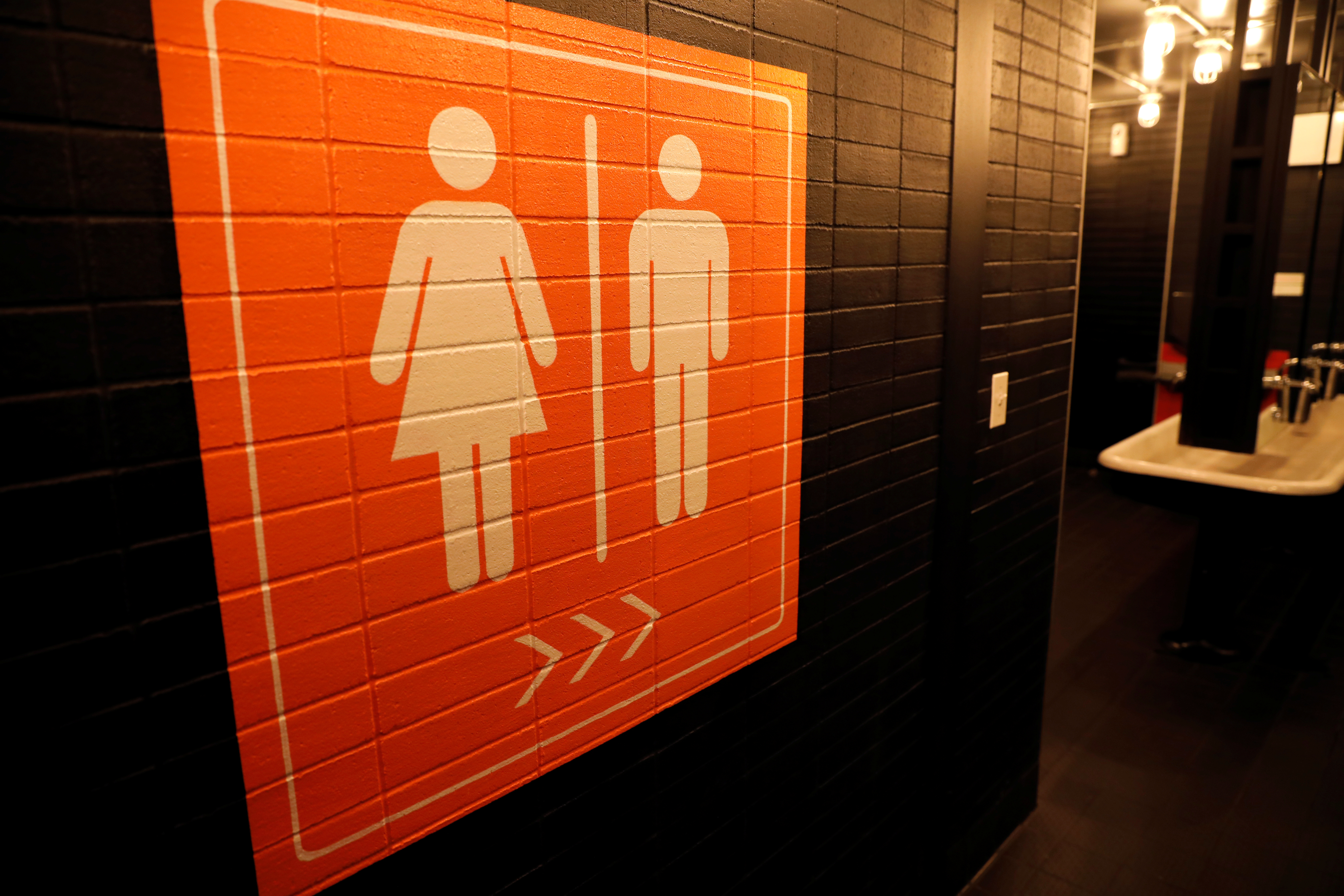 A sign is seen pointing to a gender neutral restroom in New York City