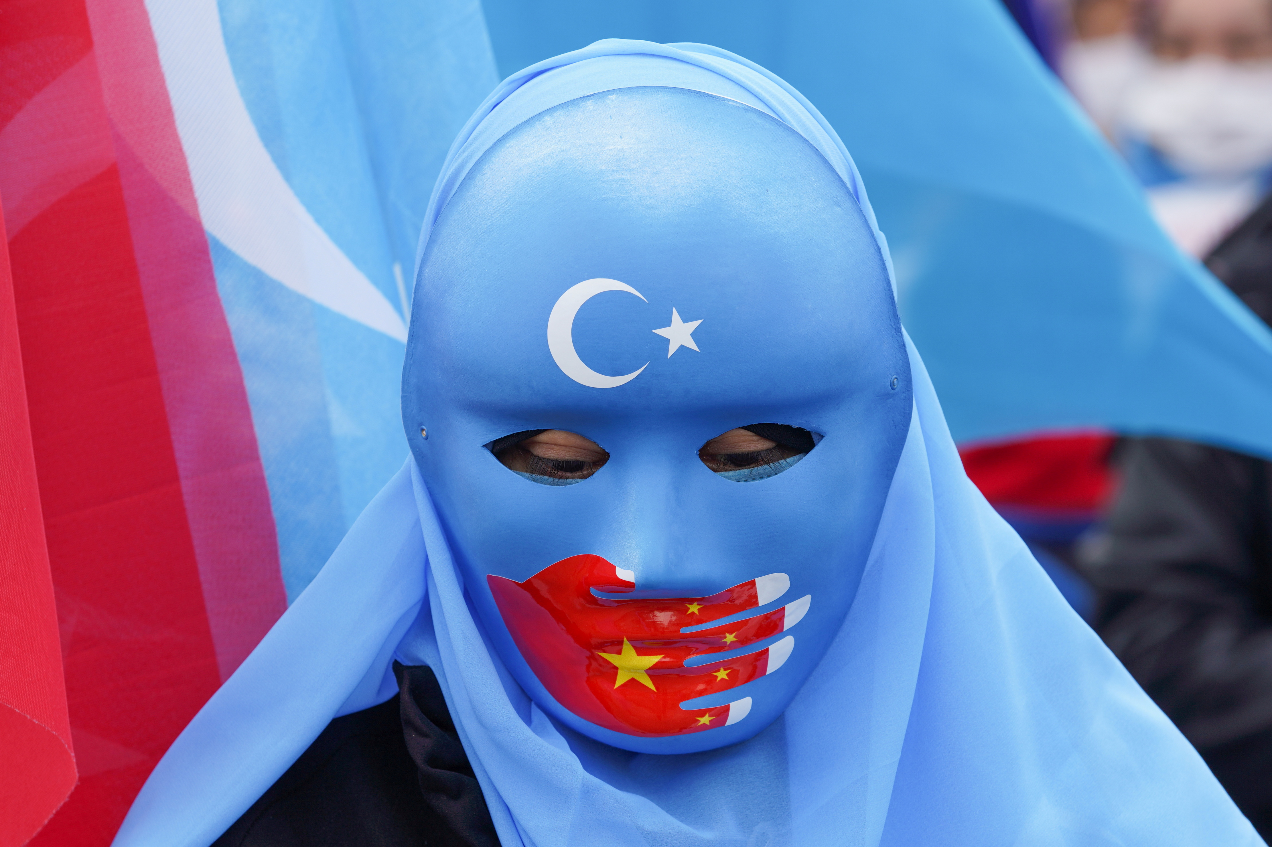 A demonstrator wearing a mask participates in a protest against Chinese State Councilor and Foreign Minister Wang Yi's visit, in Istanbul, Turkey, March 25, 2021. REUTERS/Kemal Aslan/File Photo