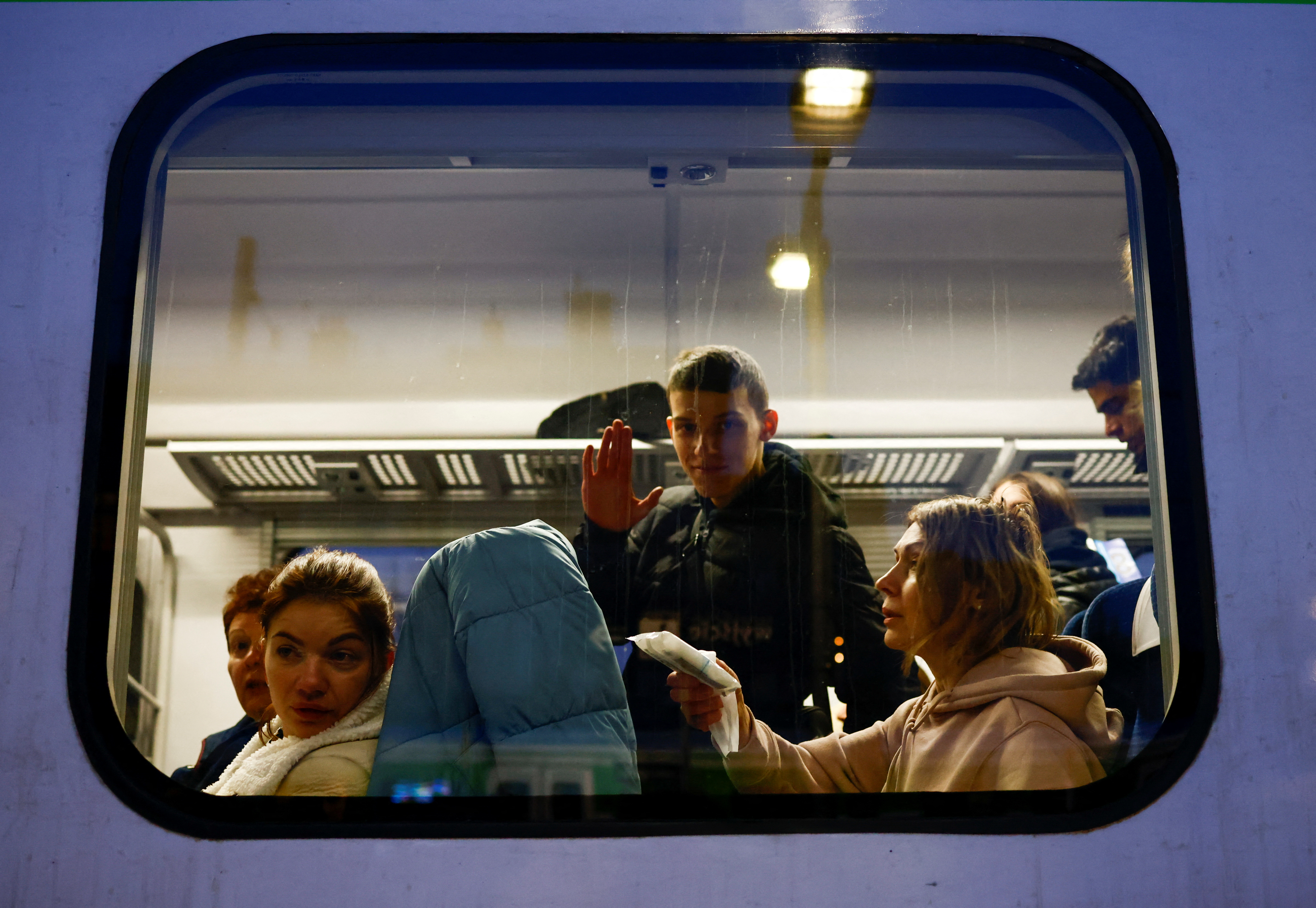 People wait at the train station after fleeing Russian invasion of Ukraine