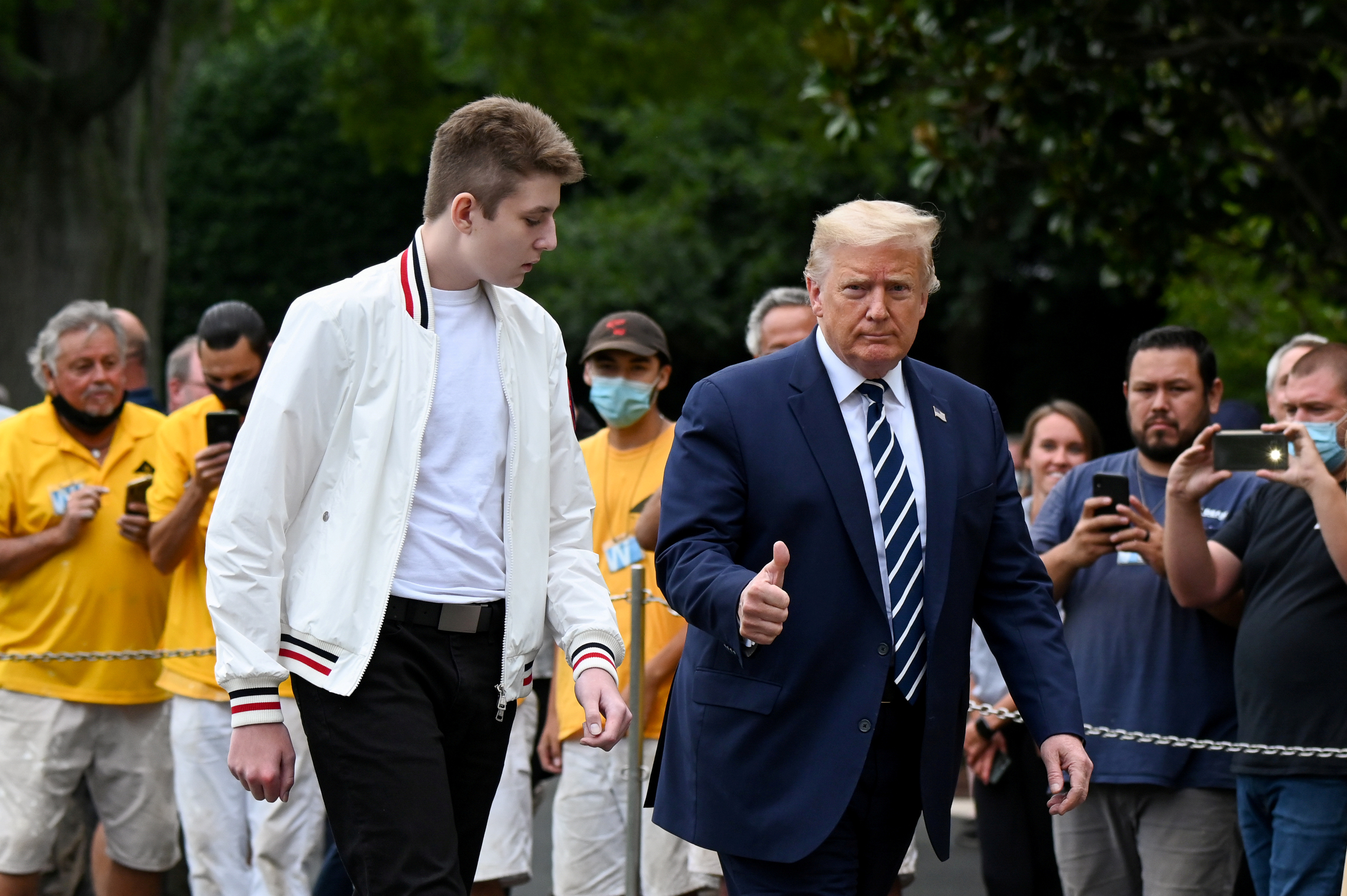 U.S. President Donald Trump and his son Barron walk to the White House from Marine One