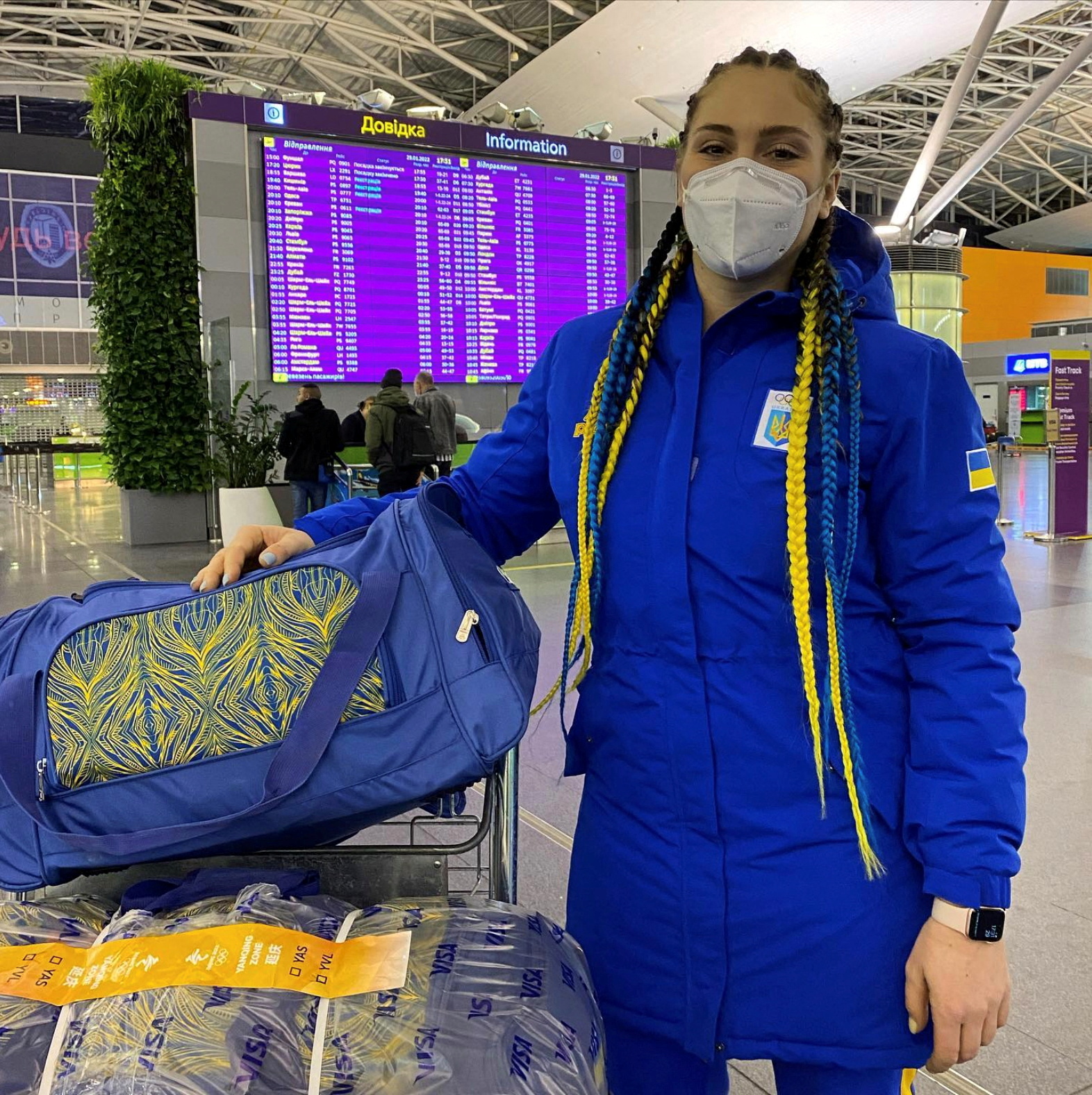 Ukrainian bobsledder, Lidiia Hunko, poses next to her luggage at Boryspil International Airport, in Kyiv Oblast
