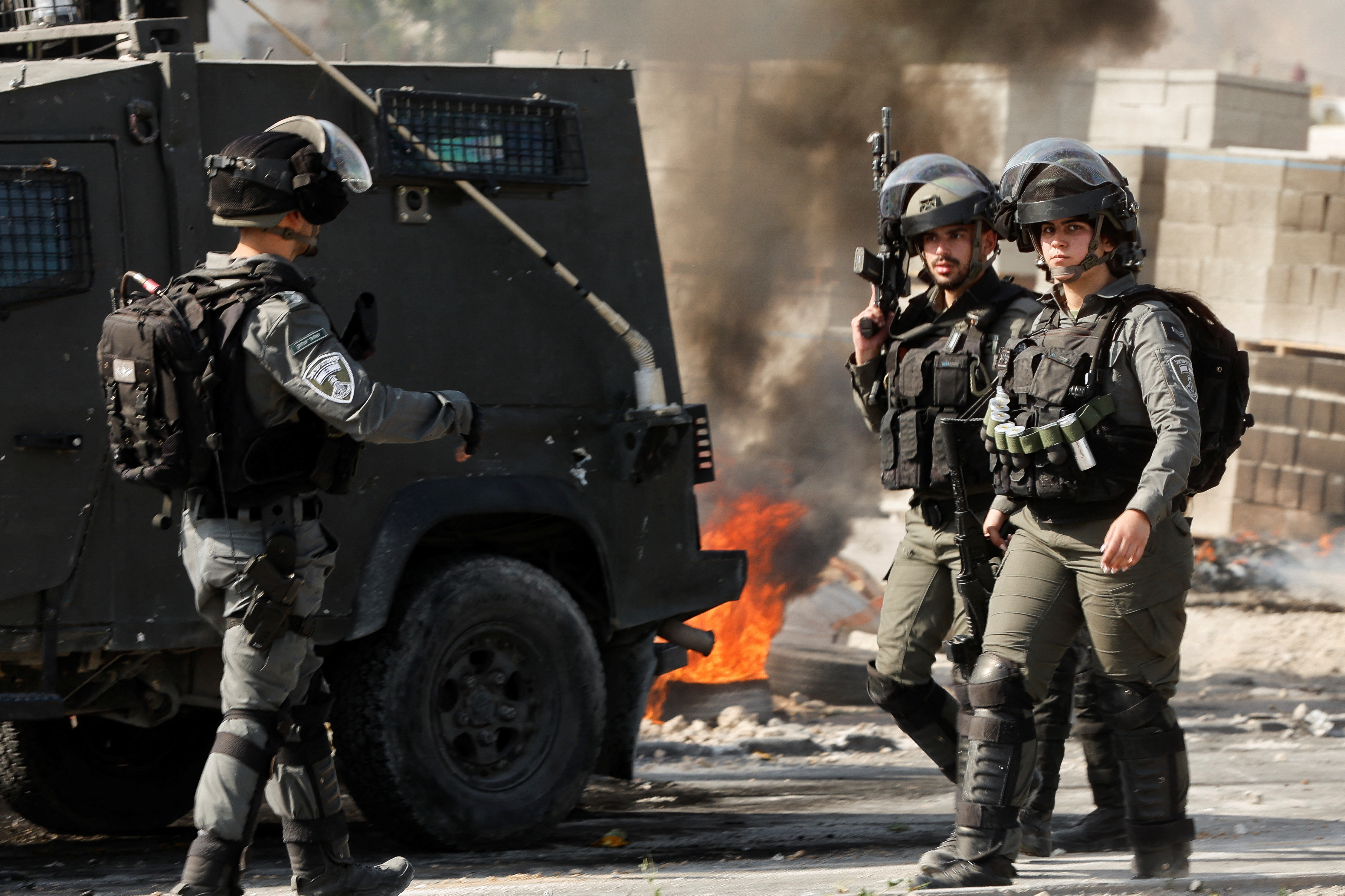 Palestinians clash with Israeli troops during a raid in Jericho