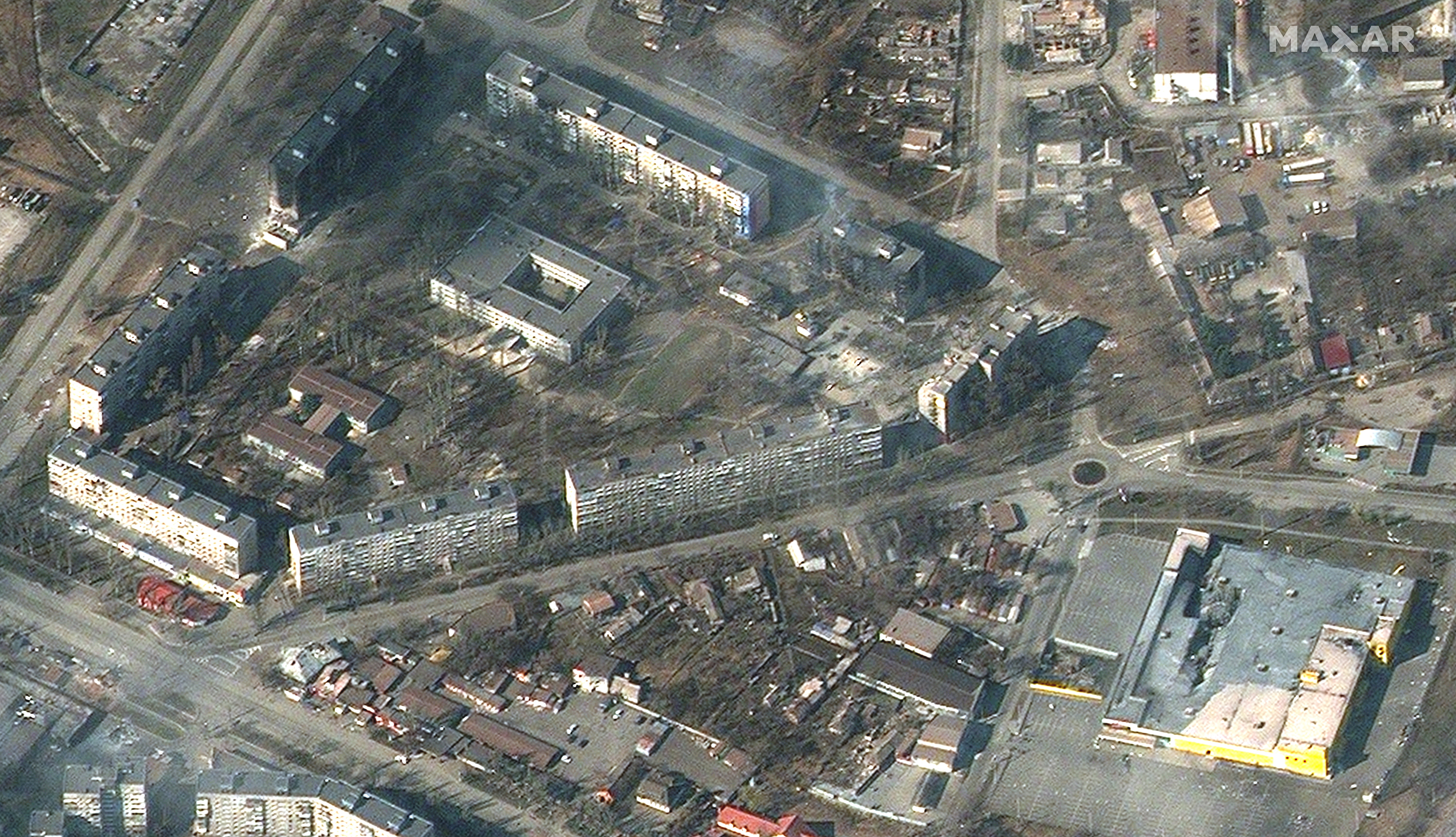 Burning and heavily damaged apartment buildings and stores in Mariupol