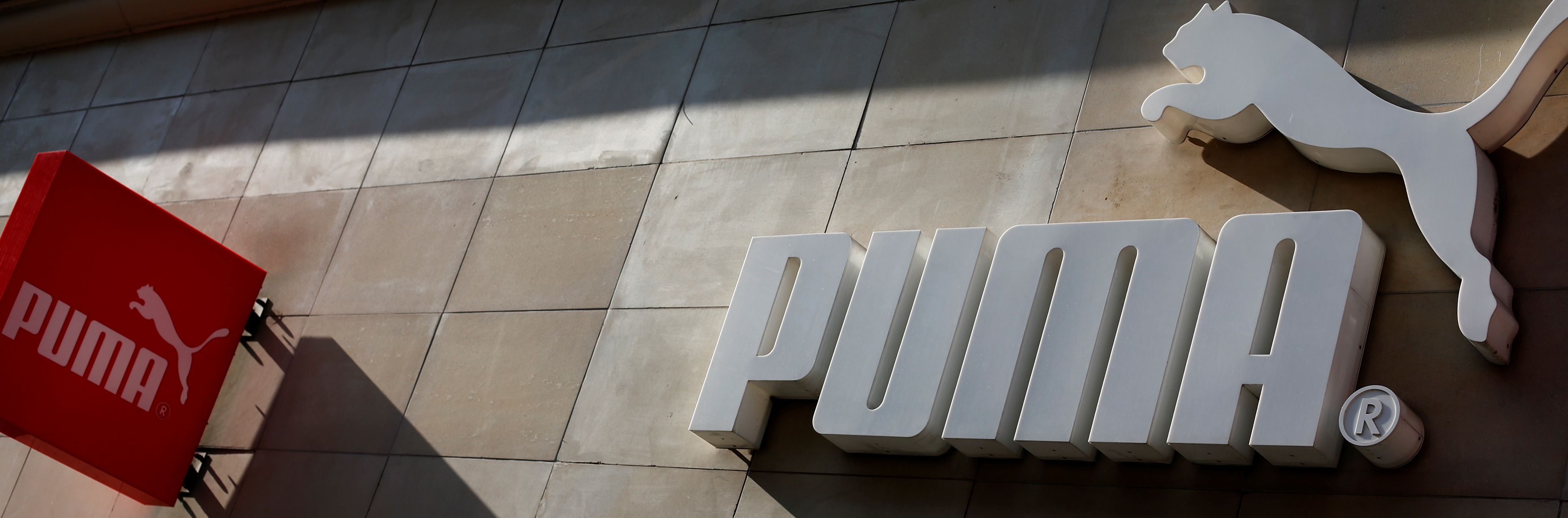 The logo of German sports goods firm Puma is seen at the entrance of one of its stores in Vienna