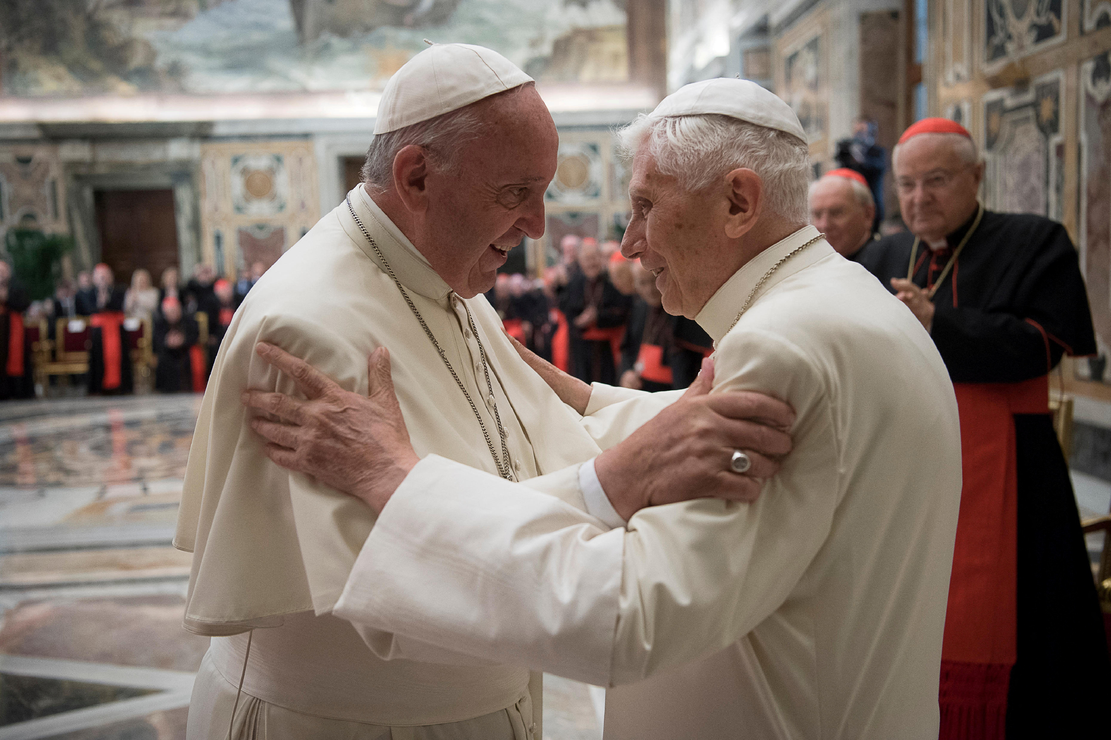 Former pope Benedict is greeted by Pope Francis during a ceremony to mark his 65th anniversary of ordination to the priesthood at the Vatican