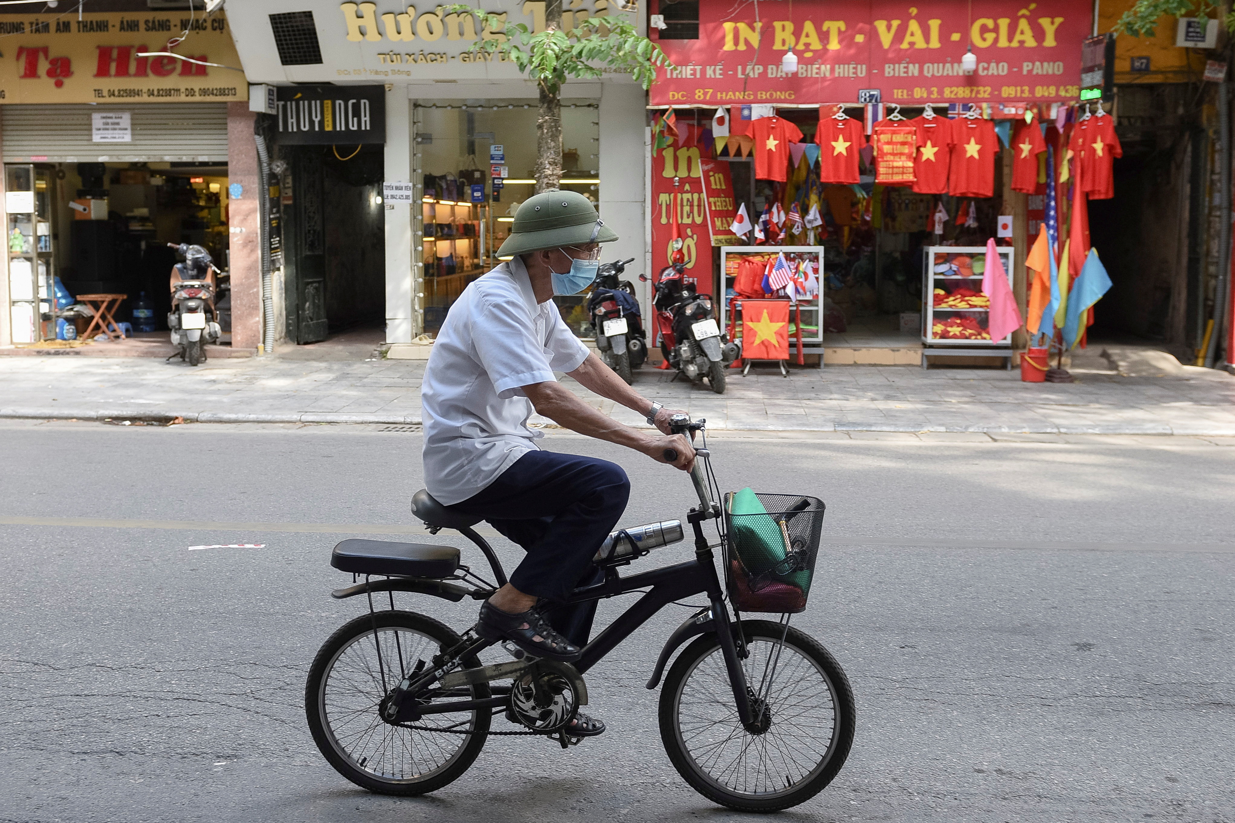 A man rides a bike on an empty street amid the coronavirus (COVID-19) pandemic, in Hanoi, Vietnam, May 31. REUTERS/Thanh Hue