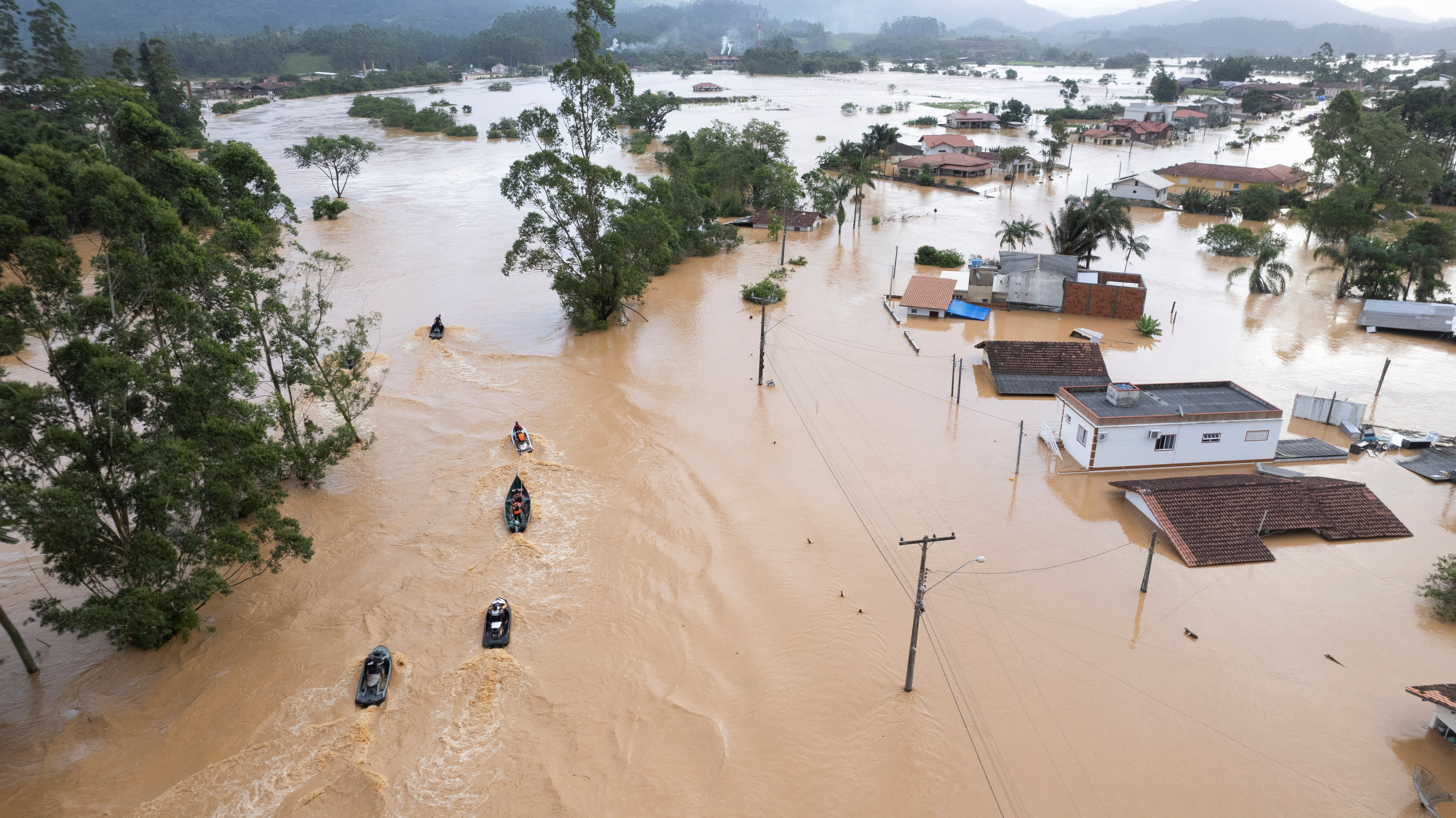 Volunteers search for residents after heavy rains in Santa Catarina